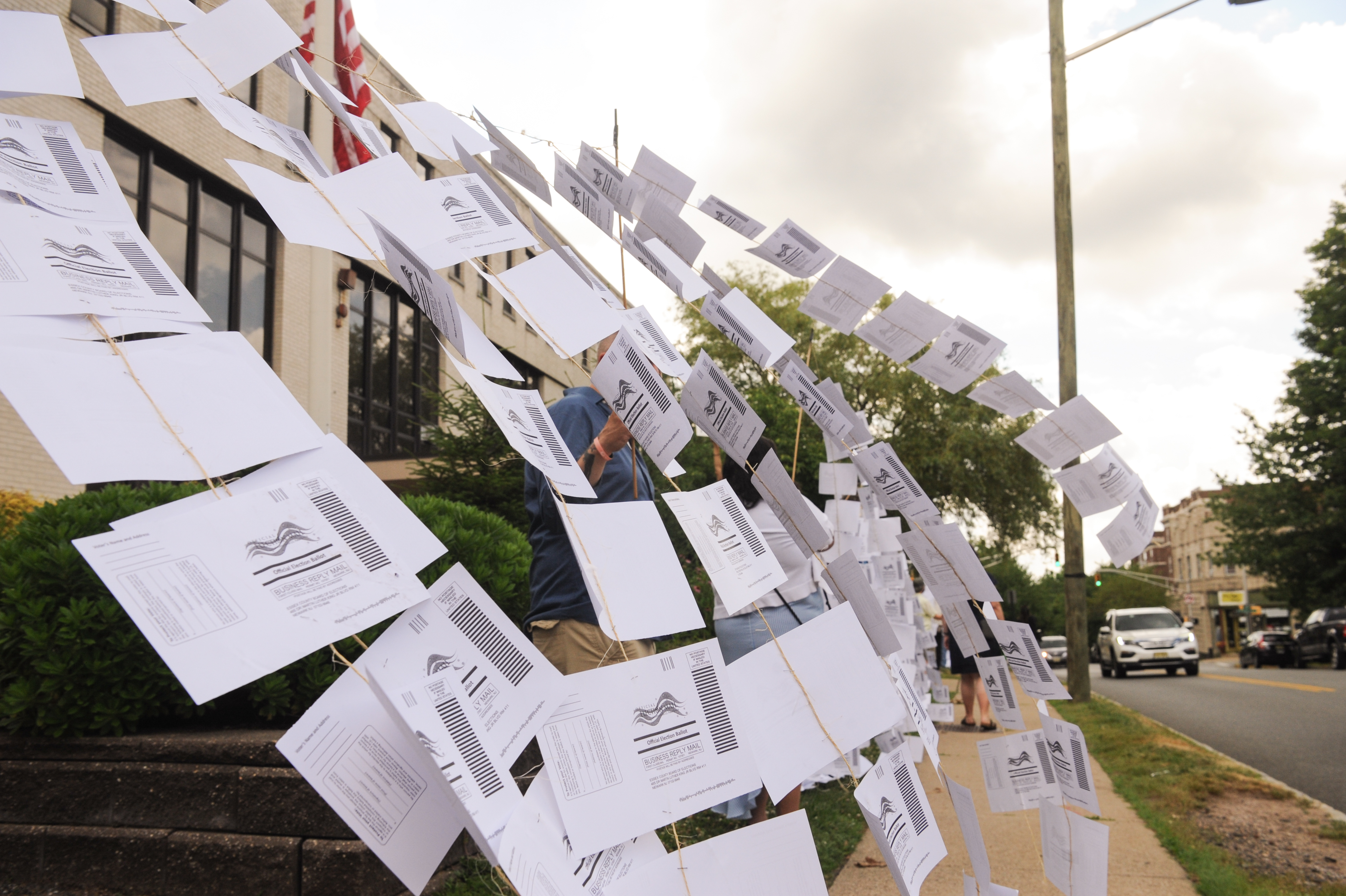 A rally outside the Montclair, N.J., town hall on July 1. Protesters hung 1,101 absentee ballots to represent the number of votes that weren't counted in a mayoral election that was decided by just 195 votes. (Montclair Local)