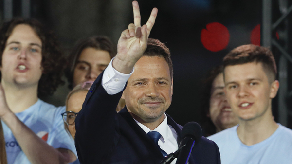 Presidential candidate and Warsaw Mayor Rafal Trzaskowski flashes a victory sign at the end of election day in Warsaw.
