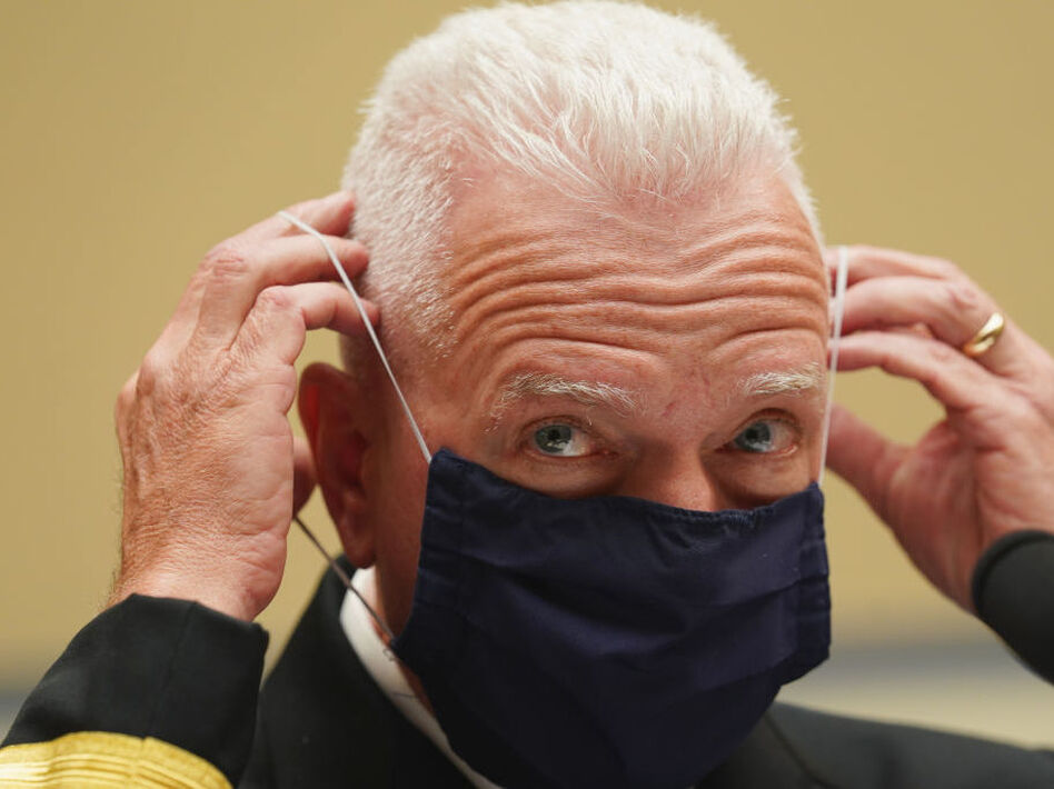 Adm. Brett Giroir, assistant secretary for health in the Department of Health and Human Services, adjusts his face mask while testifying this month before a House subcommittee on the coronavirus crisis. (Kevin Lamarque/Pool/Getty Images)