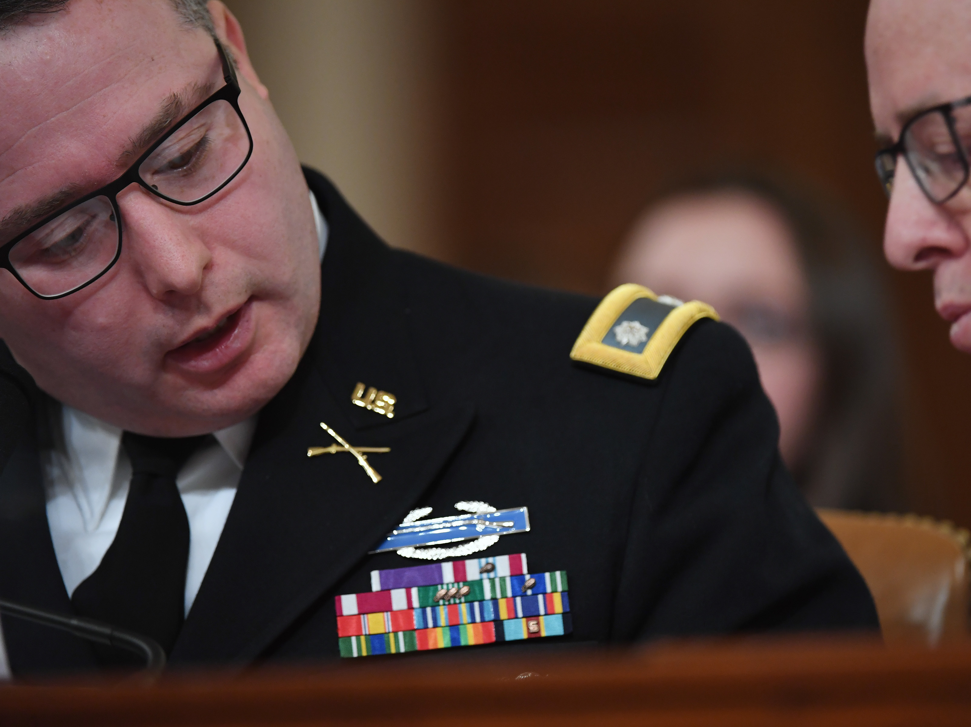 National Security Council Europe expert Lt. Col. Alexander Vindman (left) appears before the House Intelligence Committee during an impeachment hearing in November. (The Washington Post via Getty Images)