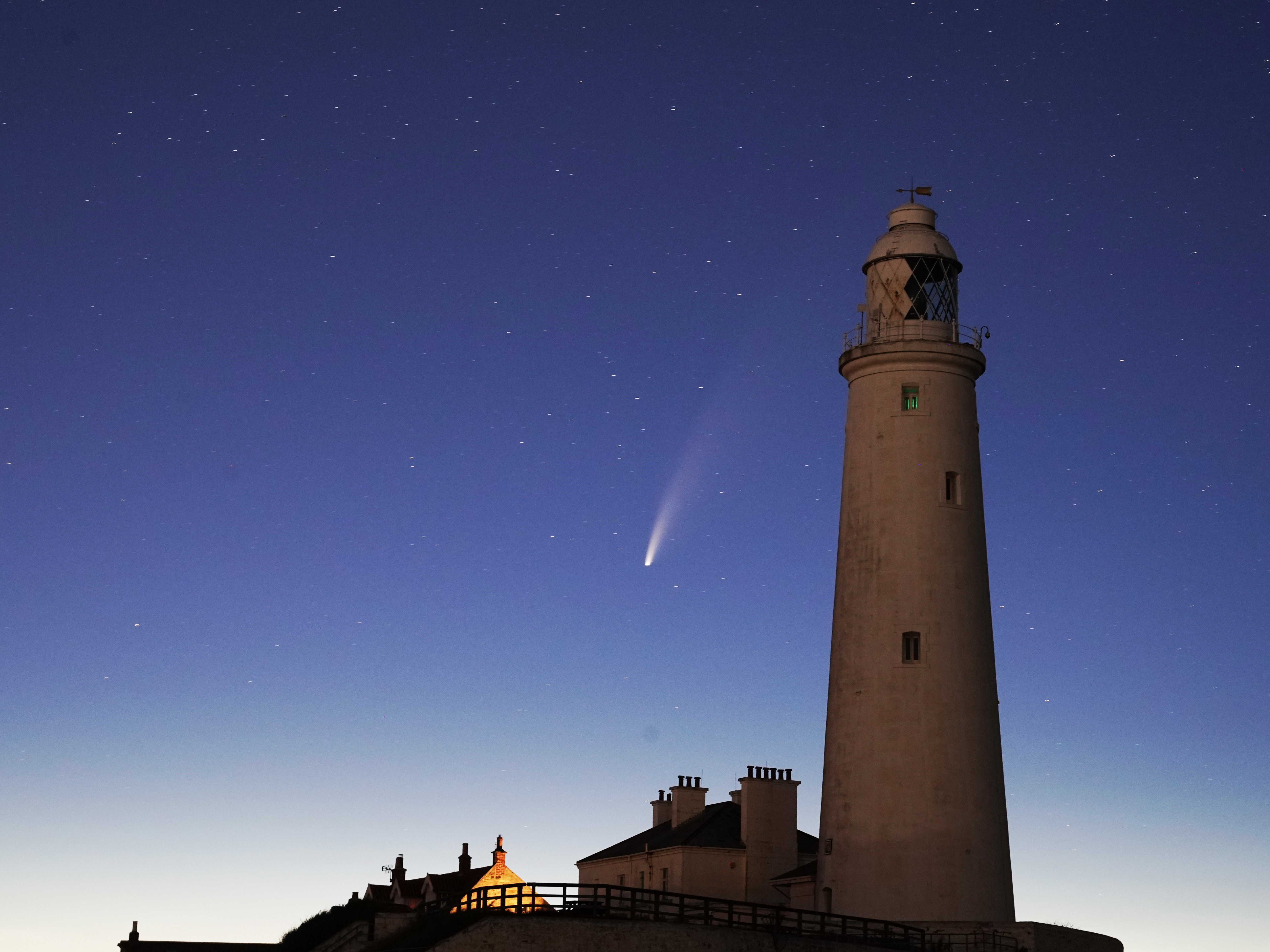 Comet Neowise passes St. Mary's Lighthouse in Whitley Bay, U.K., in the early hours of Tuesday morning. (PA Images via Getty Images)