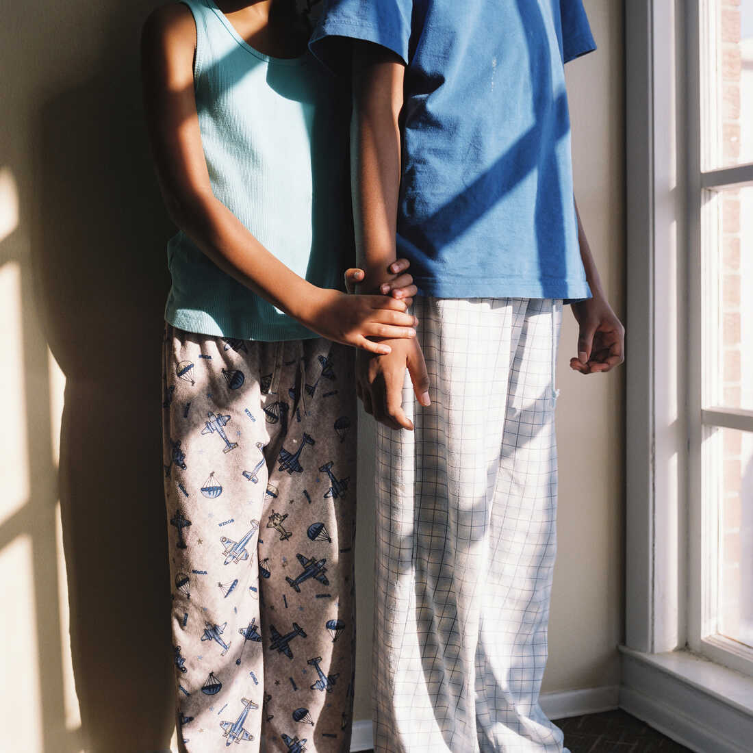 Thandi and Khaya holding each other while wearing pajamas.