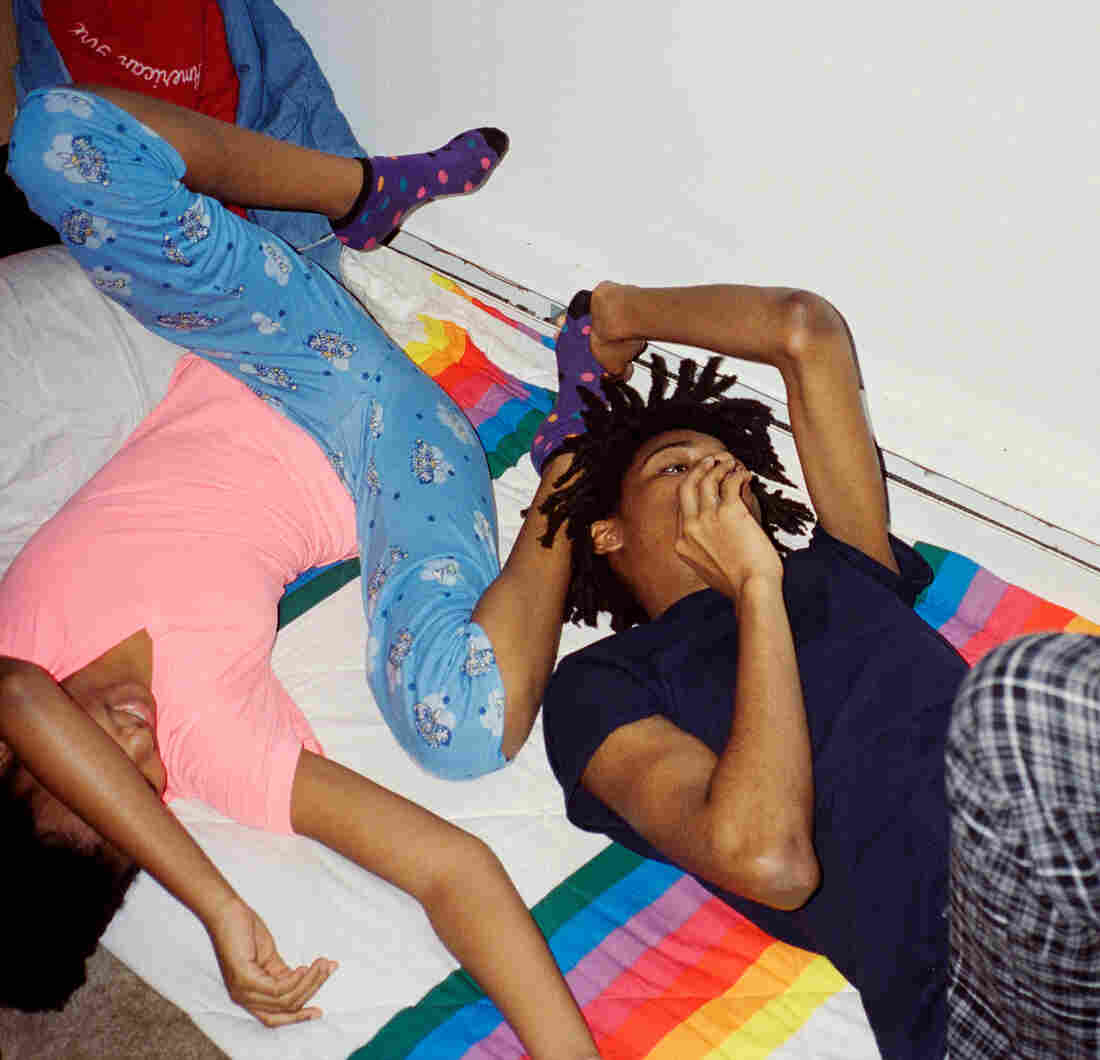 Thandi and Khaya lying down in their pajamas.