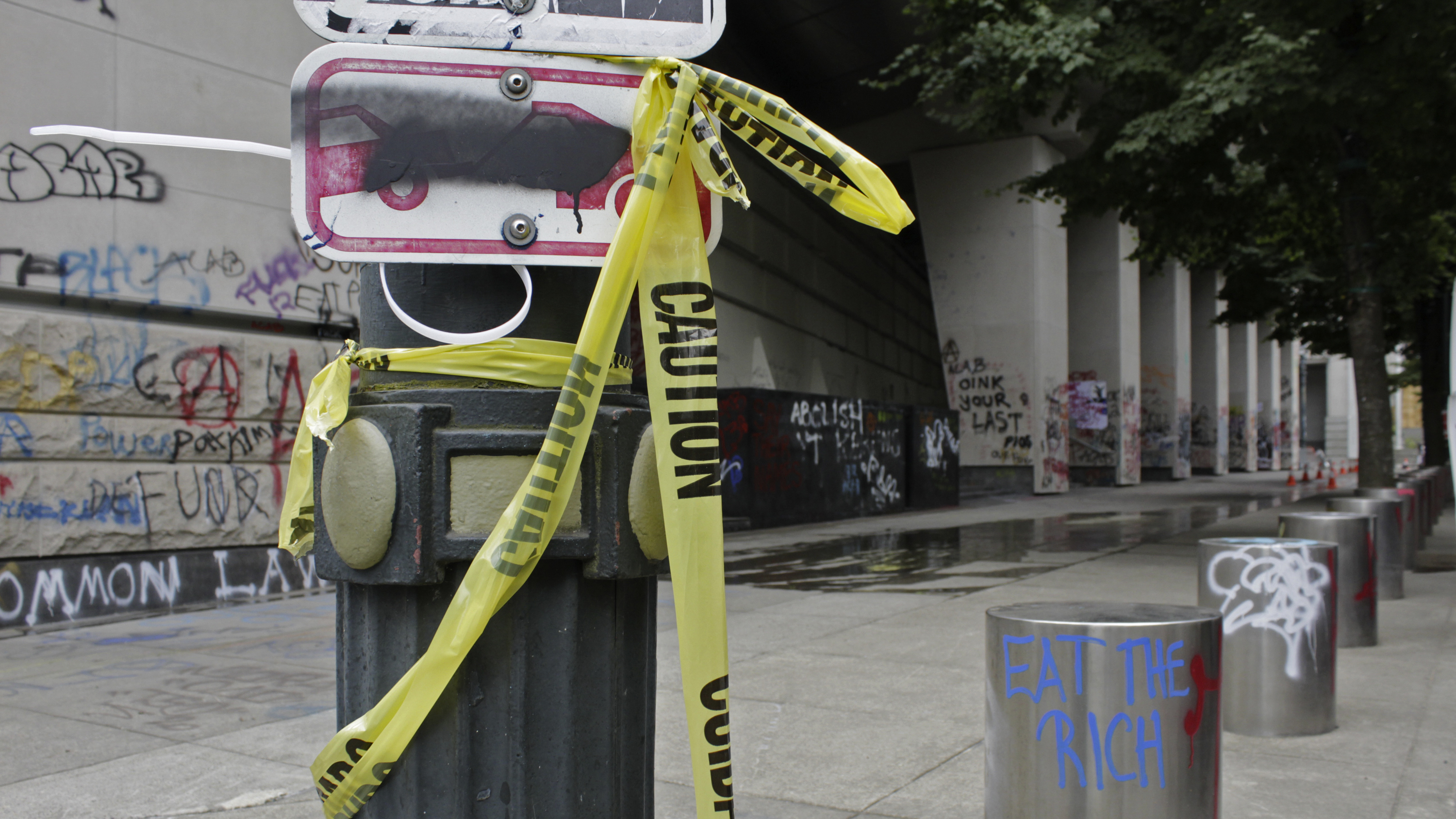 Graffiti from recent demonstrations covers an area outside the Mark O. Hatfield Federal Courthouse in Portland on July 8. Protesters are facing off not just against the Portland police but a group of federal agents.