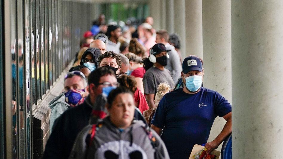 Hundreds of people line up outside a Kentucky Career Center hoping to find assistance with their unemployment claim in Frankfort, Ky., in June. (Bryan Woolston/Reuters)
