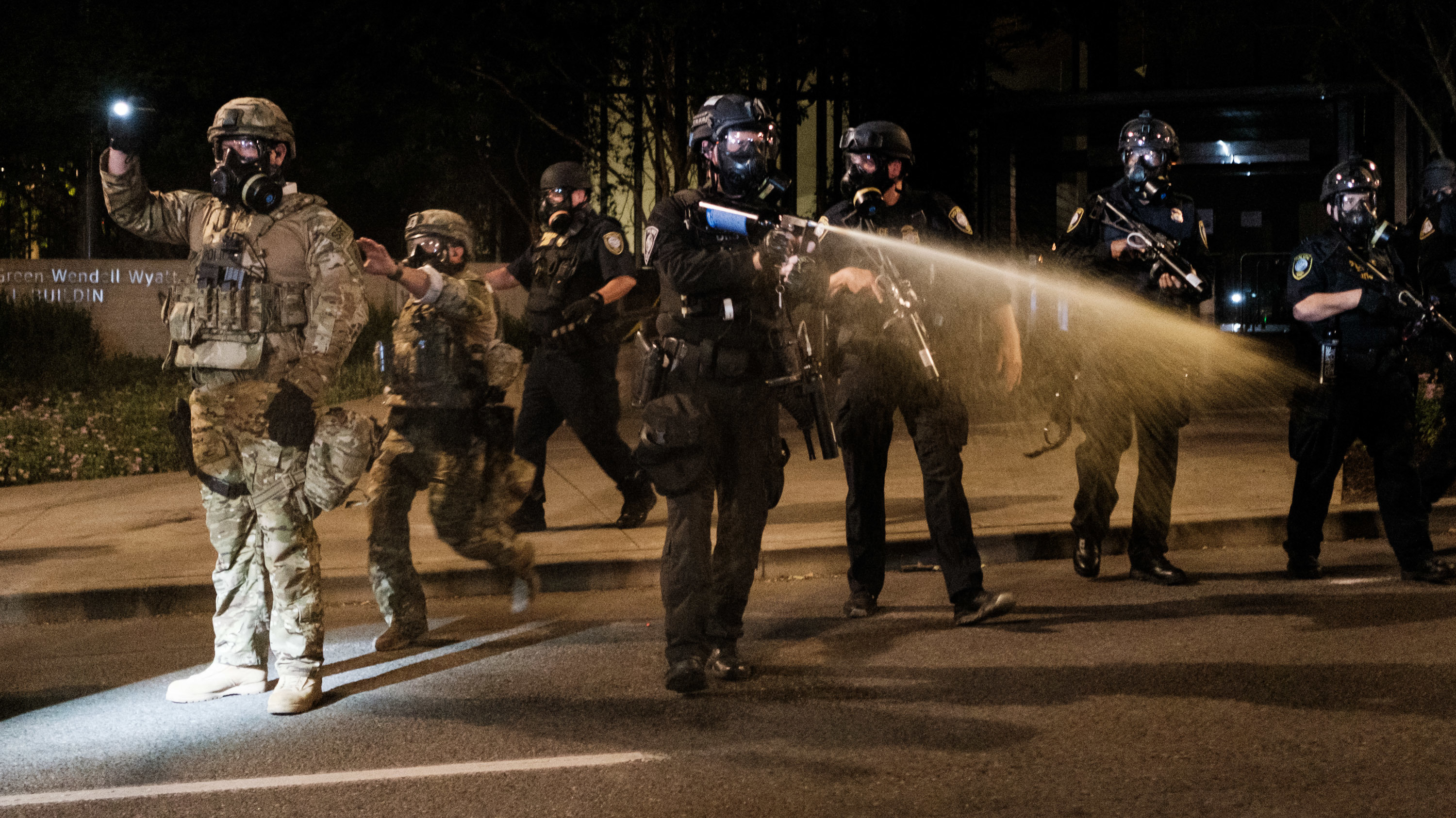 Federal officers use tear gas and other crowd dispersal munitions on protesters outside the Multnomah County Justice Center on Friday in Portland, Ore. (Getty Images)