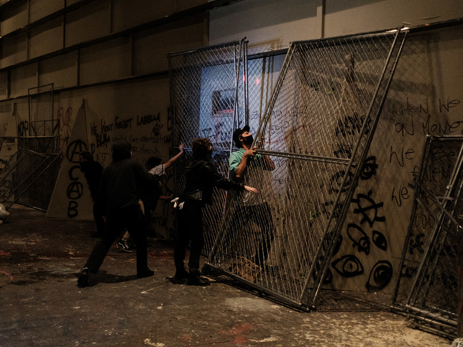 Protesters attempt to barricade the entrance to the U.S. District Court building on July 17 in Portland, Oregon. (Mason Trinca/Getty Images)