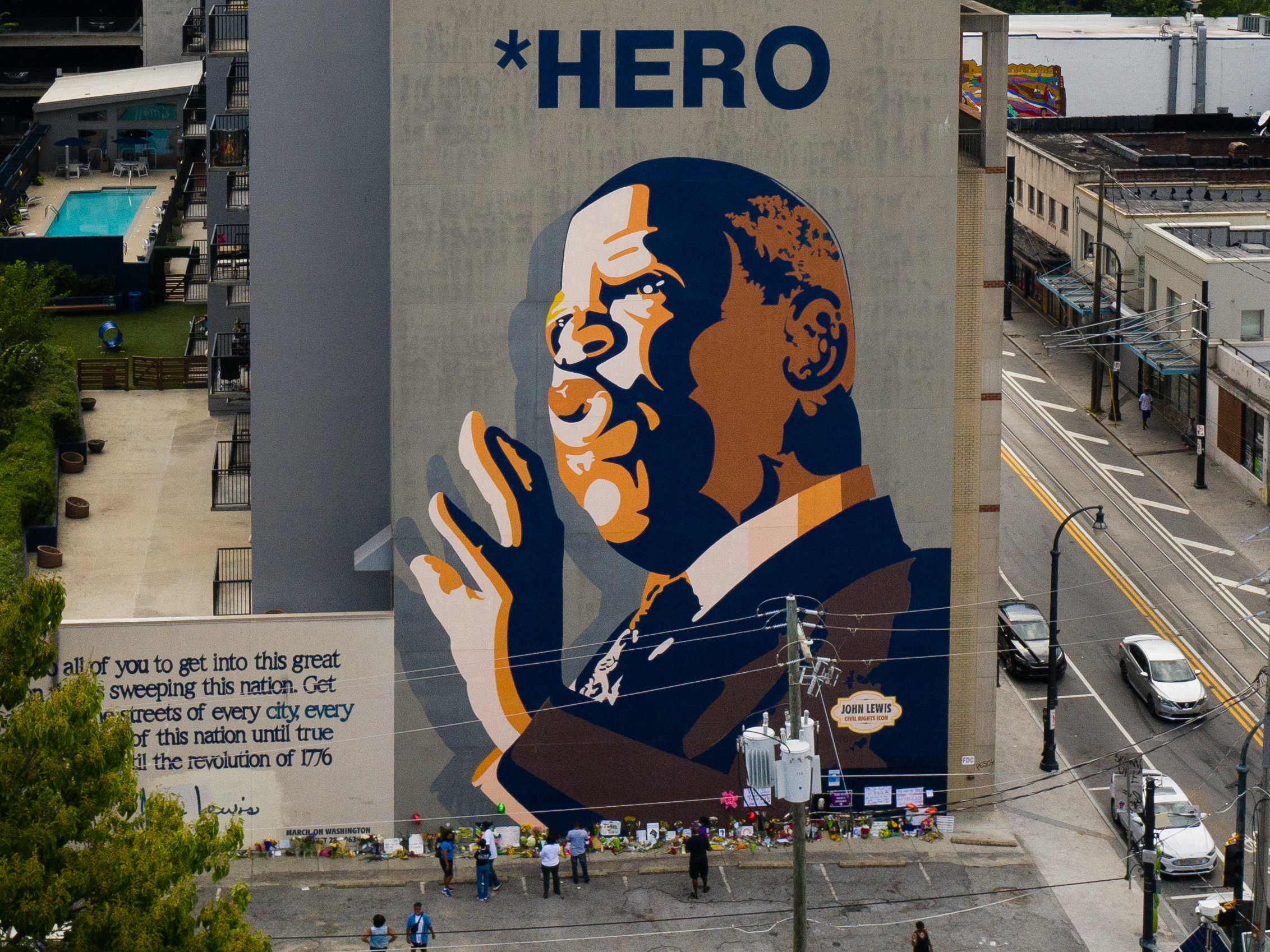Mourners pay their respects at a mural of Rep. John Lewis painted on a building in Atlanta. The civil rights icon and congressman died on Friday. (Getty Images)