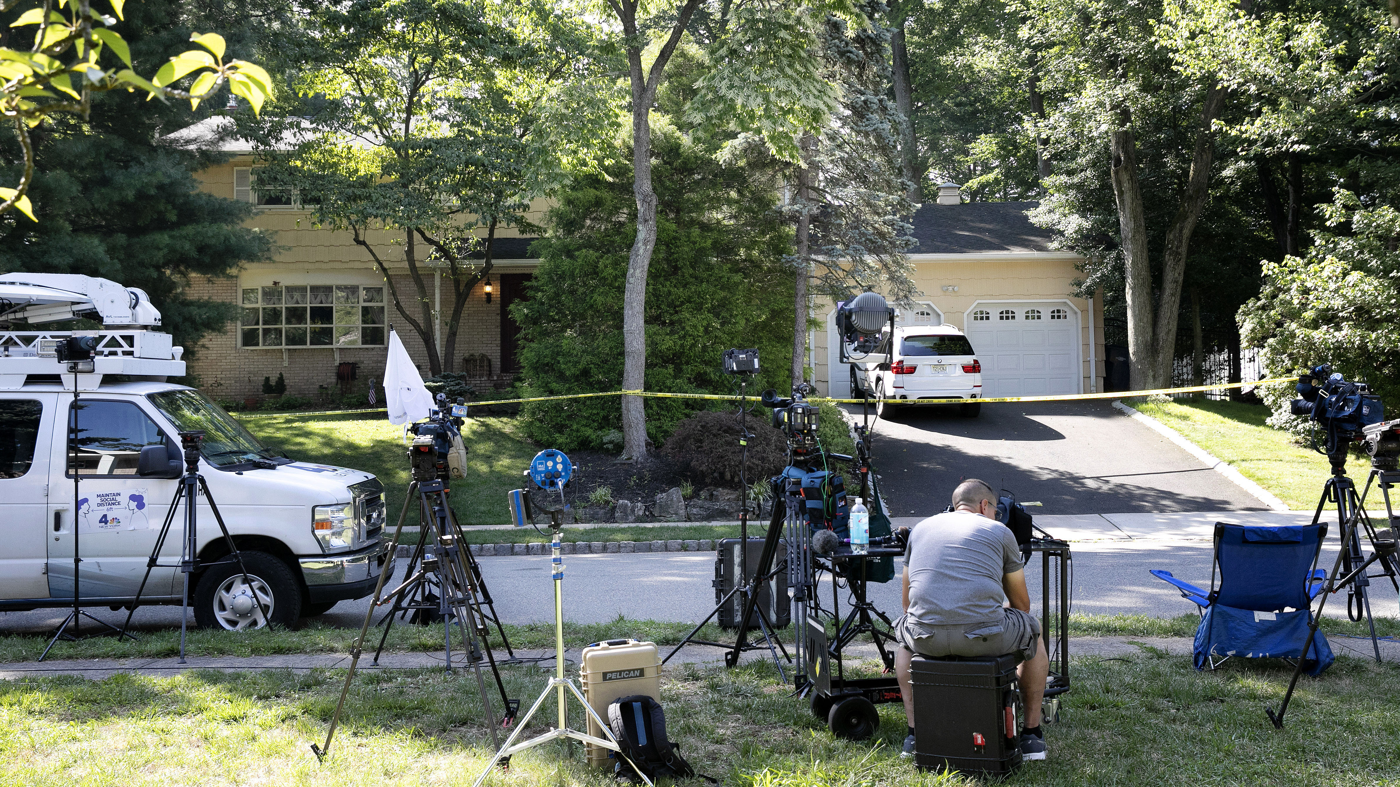 News media set up in front of the home of U.S. District Judge Esther Salas on Monday in North Brunswick, N.J. A gunman posing as a delivery person shot and killed Salas