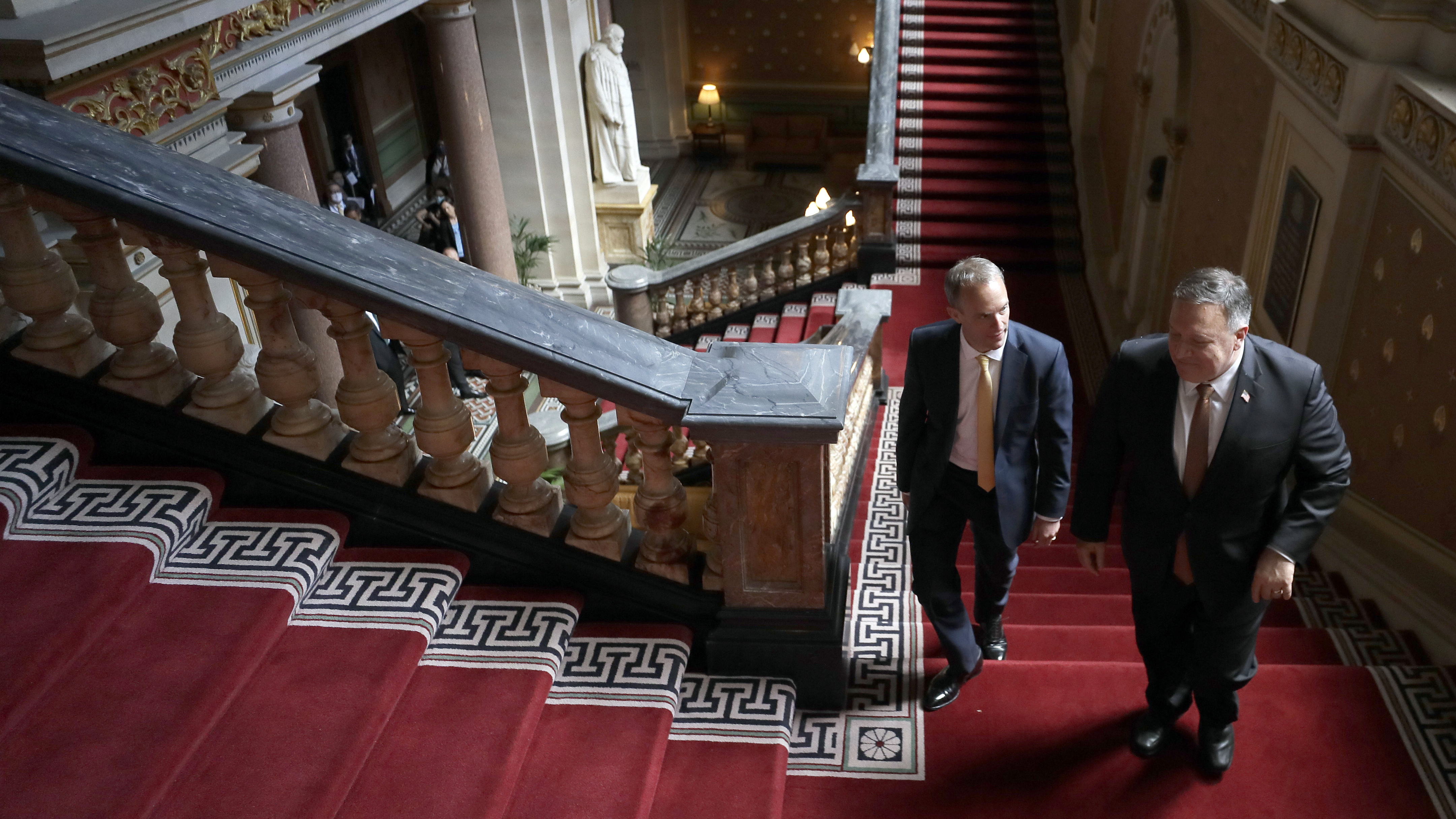 U.K. Foreign Secretary Dominic Raab, left, and U.S. Secretary of State Mike Pompeo walk up the stairs in the Foreign Office in London on Tuesday.