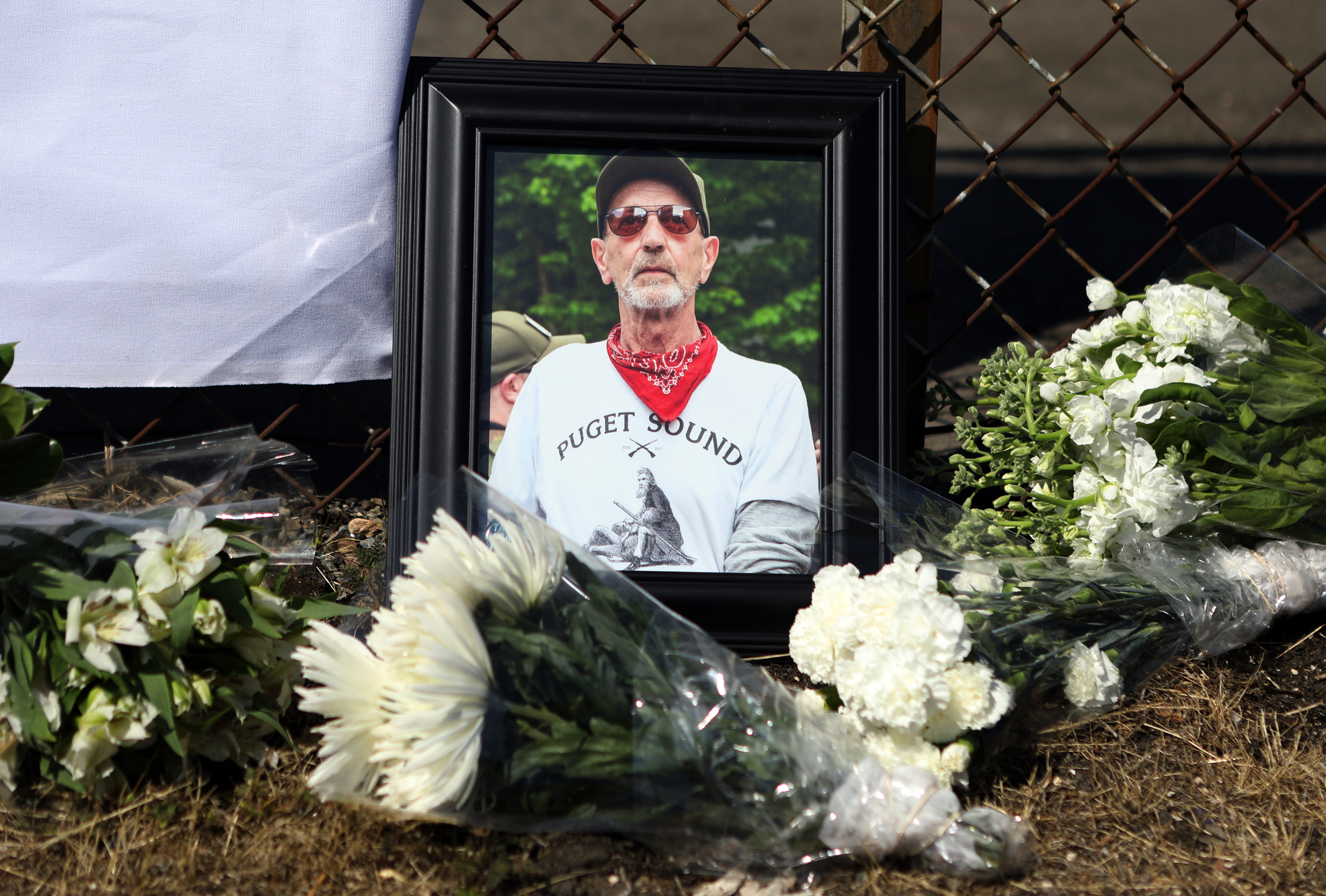 Members of the Puget Sound John Brown Gun Club hold a memorial service for Willem van Spronsen on July 28, 2019, at the site where he was killed by law enforcement outside an Immigration and Customs Enforcement facility in Tacoma, Washington. (Jim Urquhart for NPR)