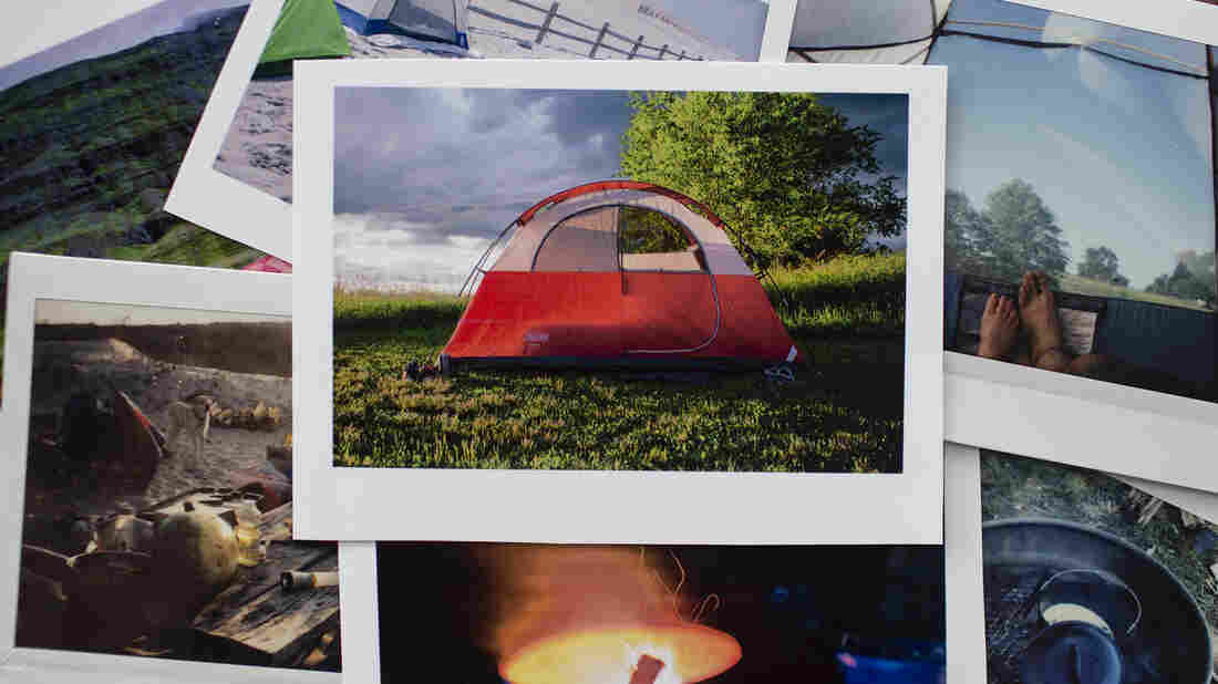 A photo of a pile of polaroid pictures depicting different scenes from camping â a red tent in the center of the pile.