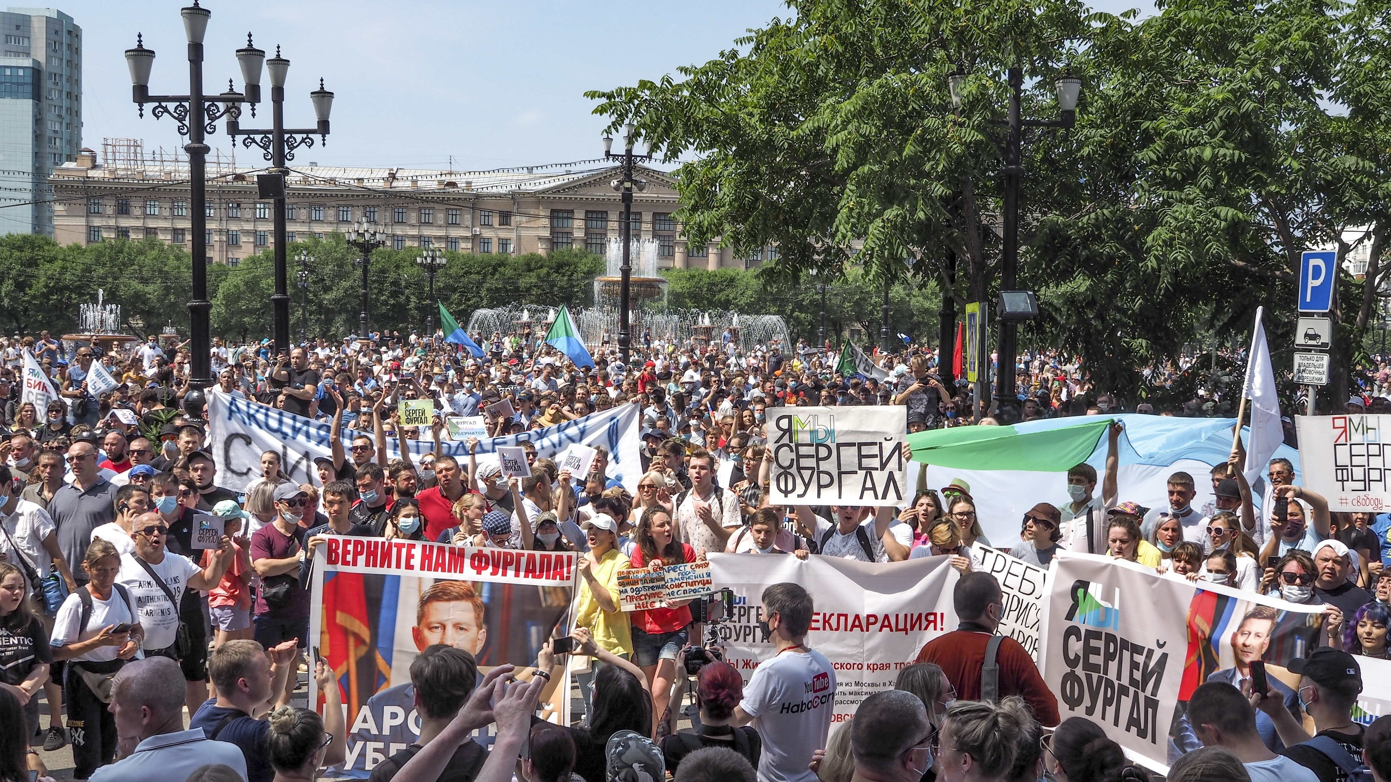 People in the city of Khabarovsk hold posters with messages demanding freedom for Sergei Furgal, the former governor of Russia