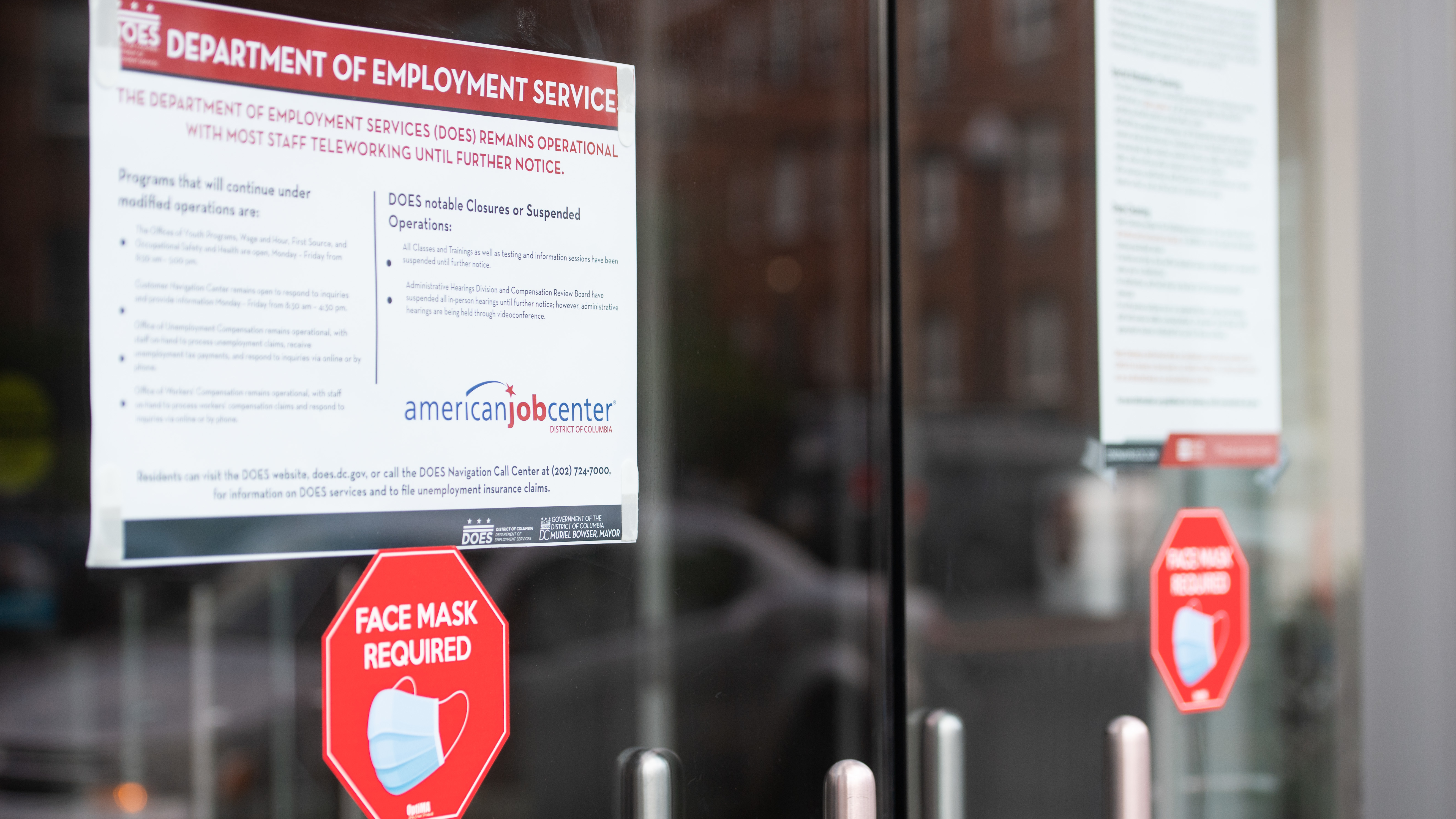 Signs are displayed outside the Washington, D.C., Department of Employment Services. New claims for unemployment benefits around the country rose for the first time in four months. (AFP via Getty Images)