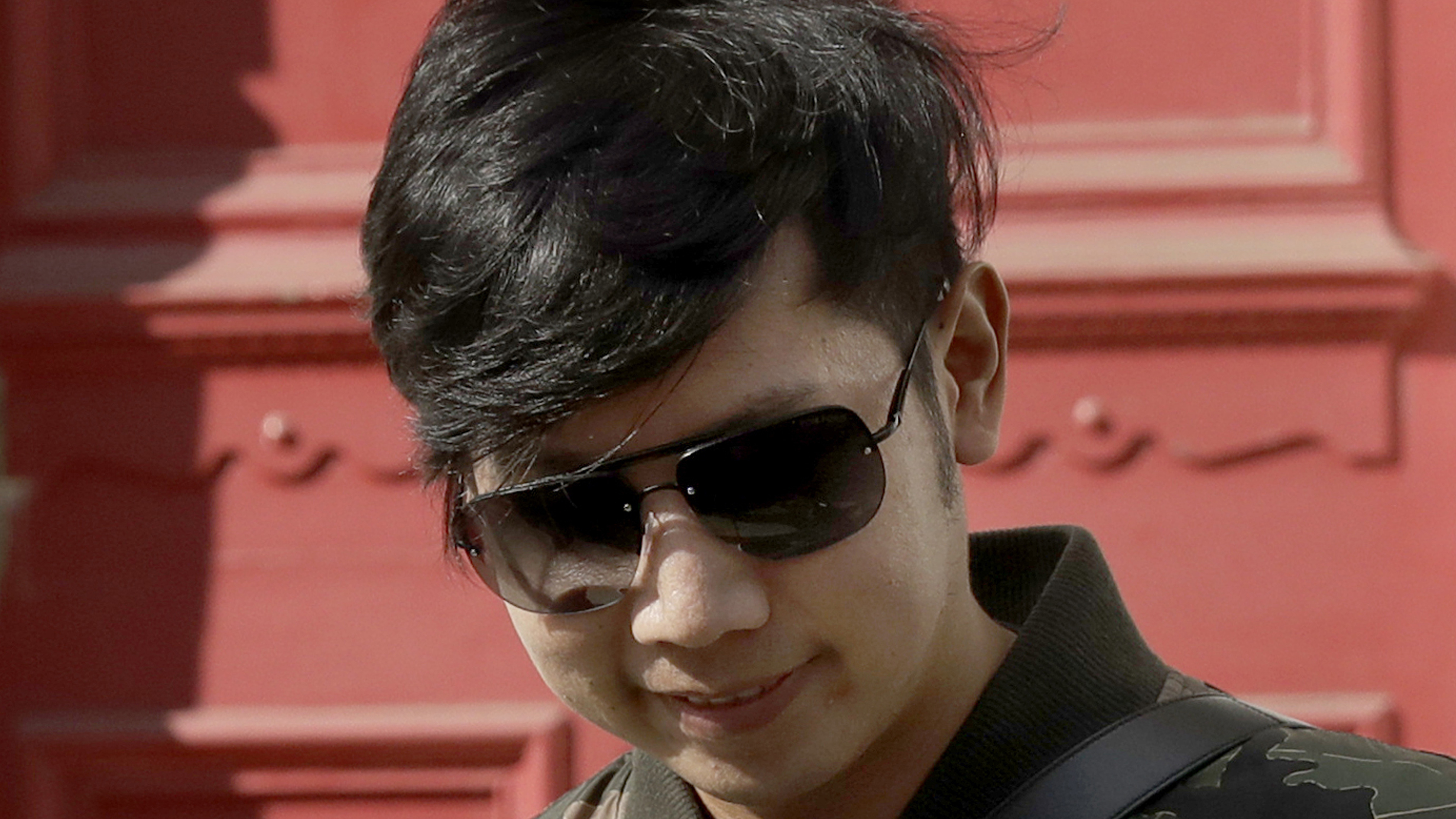 Vorayuth "Boss" Yoovidhya, whose grandfather co-founded energy drink company Red Bull, walks to get in a car as he leaves a house in London, in April 2017. Charges have been dropped against the Thai heir to the Red Bull energy drink fortune who is accused in a 2012 car crash that killed a Bangkok police officer.