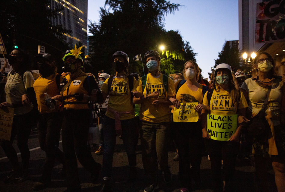 The Wall of Moms marches to the Multnomah County Justice Center in Portland, Ore., July 25, 2020. Portland has sustained protests against police brutality and systemic racism for 58 days. (Bradley W. Parks/OPB)