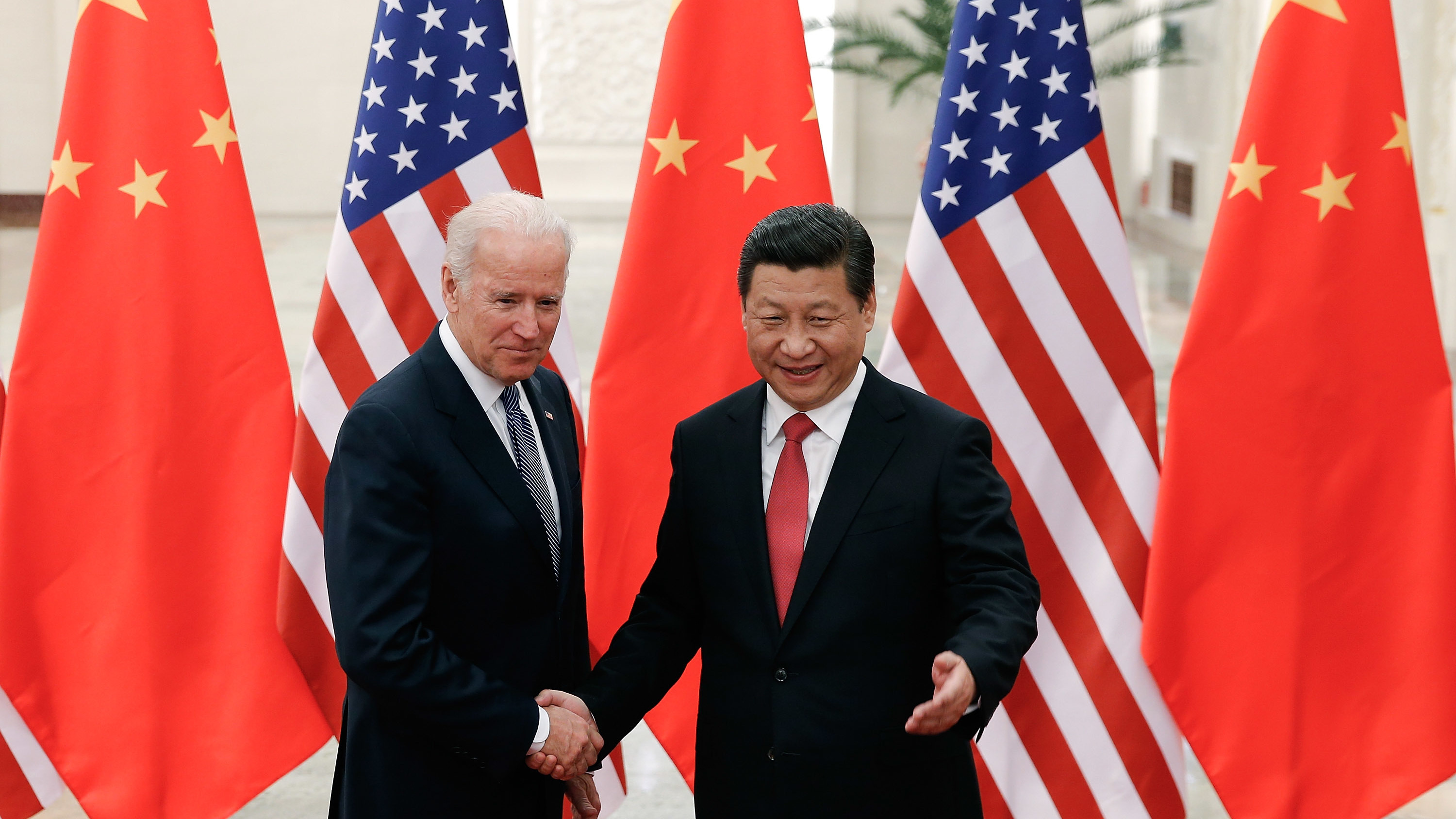 Then-Vice President Joe Biden shakes hands with Chinese President Xi Jinping in Beijing on Dec. 4, 2013. &quot;I've traveled 17,000 miles with him,&quot; Biden told attendees at a campaign rally in Nevada earlier this year. (AFP via Getty Images)