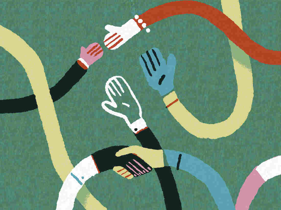 Multicolored hands grasping each other.