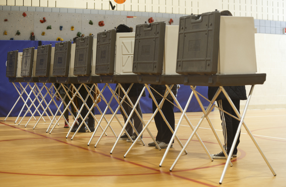 Voters cast their ballots at a polling place at Cromie Elementary School in Warren, Mich., in March. Warren is in Macomb County, considered a critical suburb in the presidential election. (Elaine Cromie/Getty Images)
