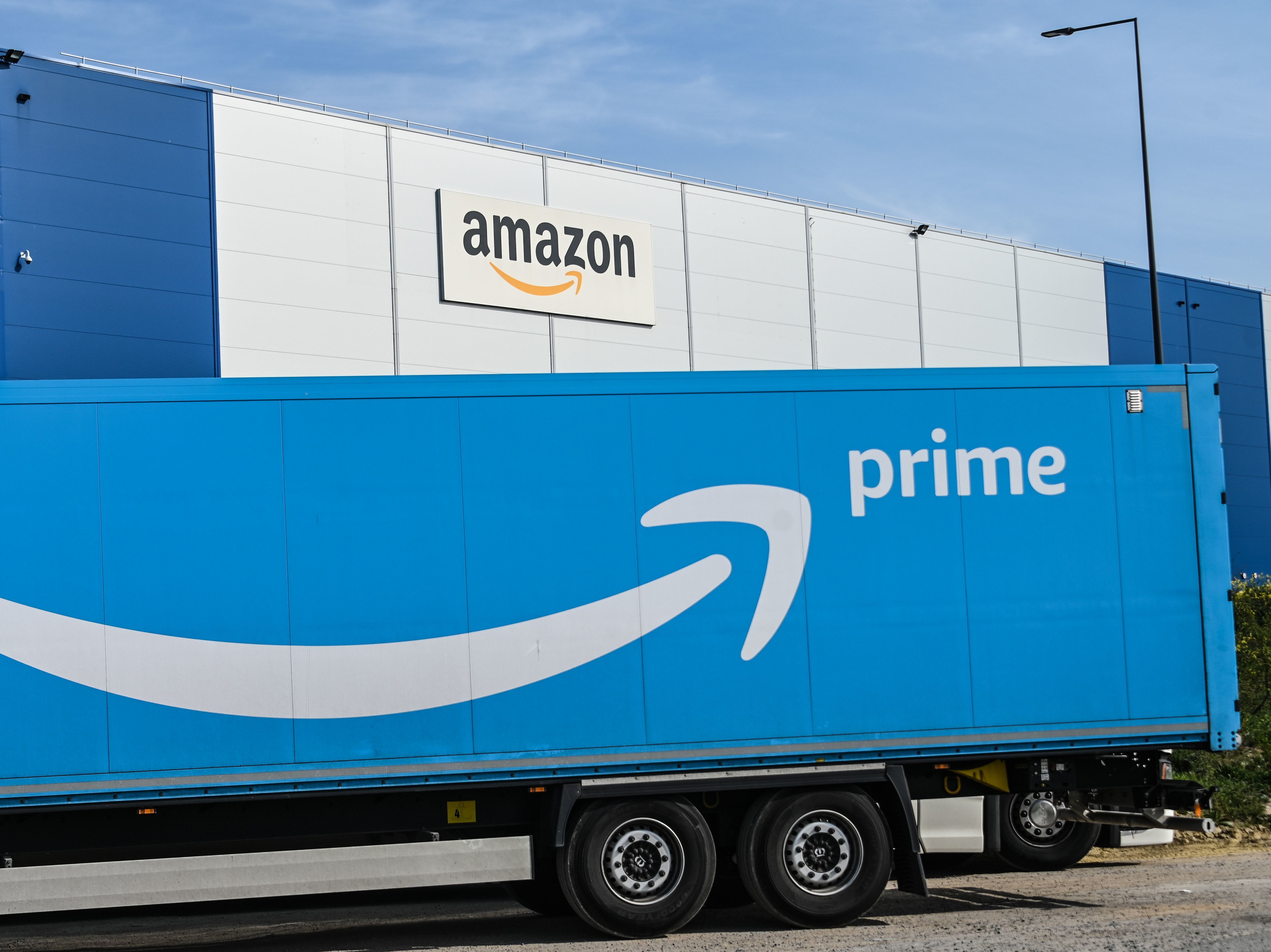 An Amazon delivery truck is parked outside a warehouse in France on April 16. The online retail giant's revenues and profits soared in the second quarter. (AFP/Getty Images)
