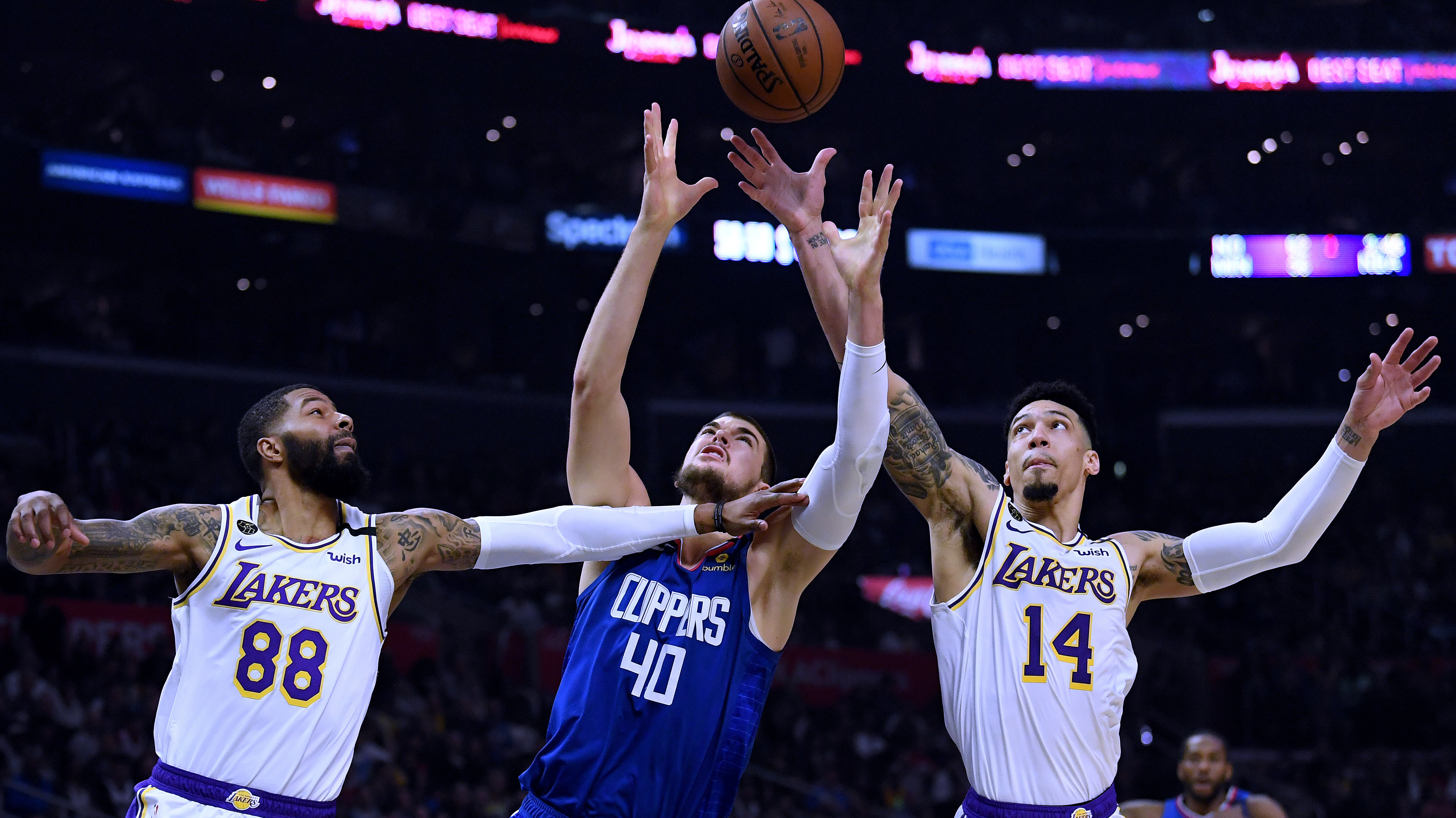 Players from the Los Angeles Clippers and Los Angeles Lakers, shown here during a game in March, will face each other on Thursday evening as the NBA season restarts.