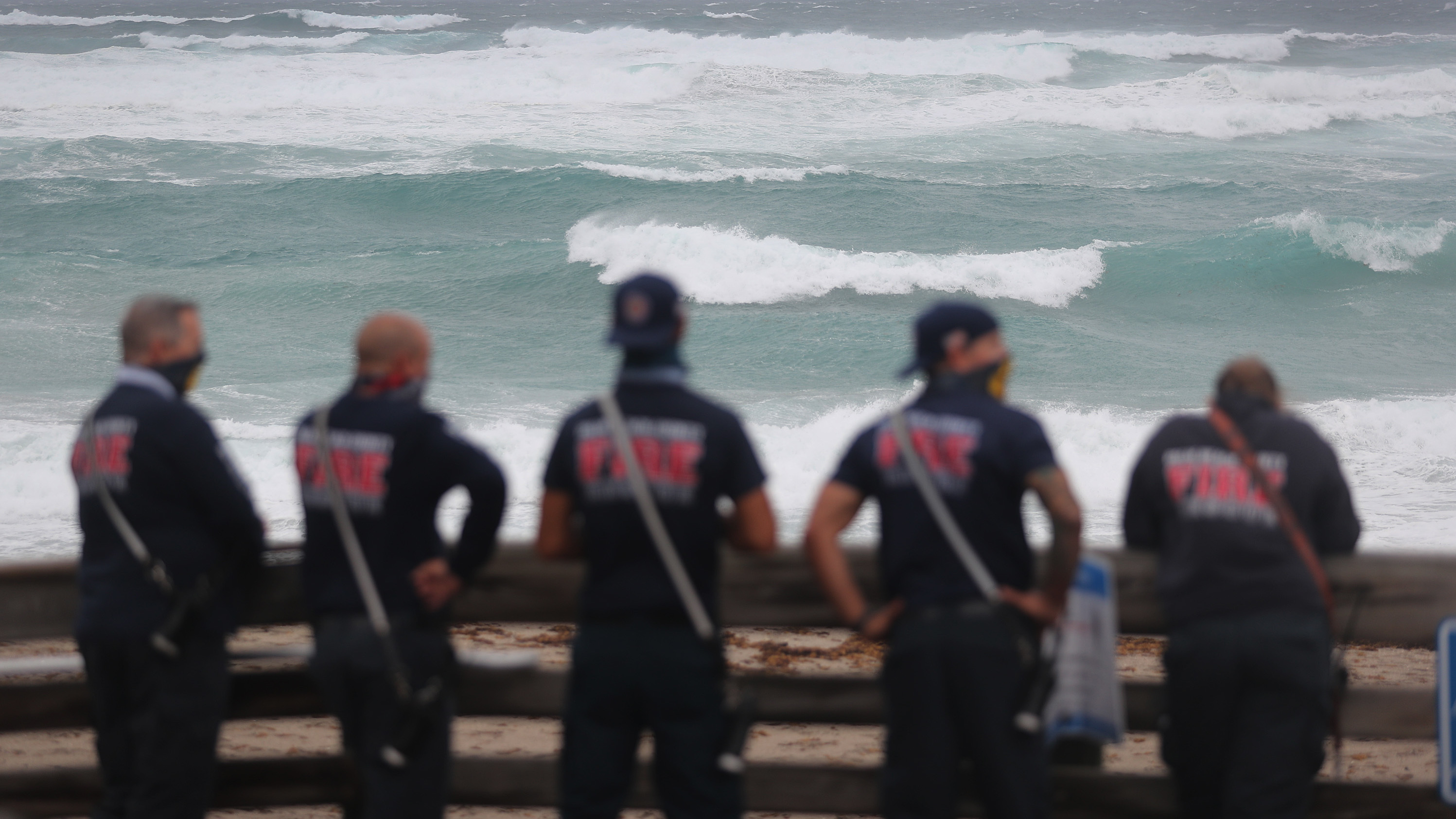 Palm Beach County Fire Rescue check out the ocean as waves crash ashore from Tropical Storm Isaias as it passes through the area on August 2, 2020 in Juno Beach, Fla.