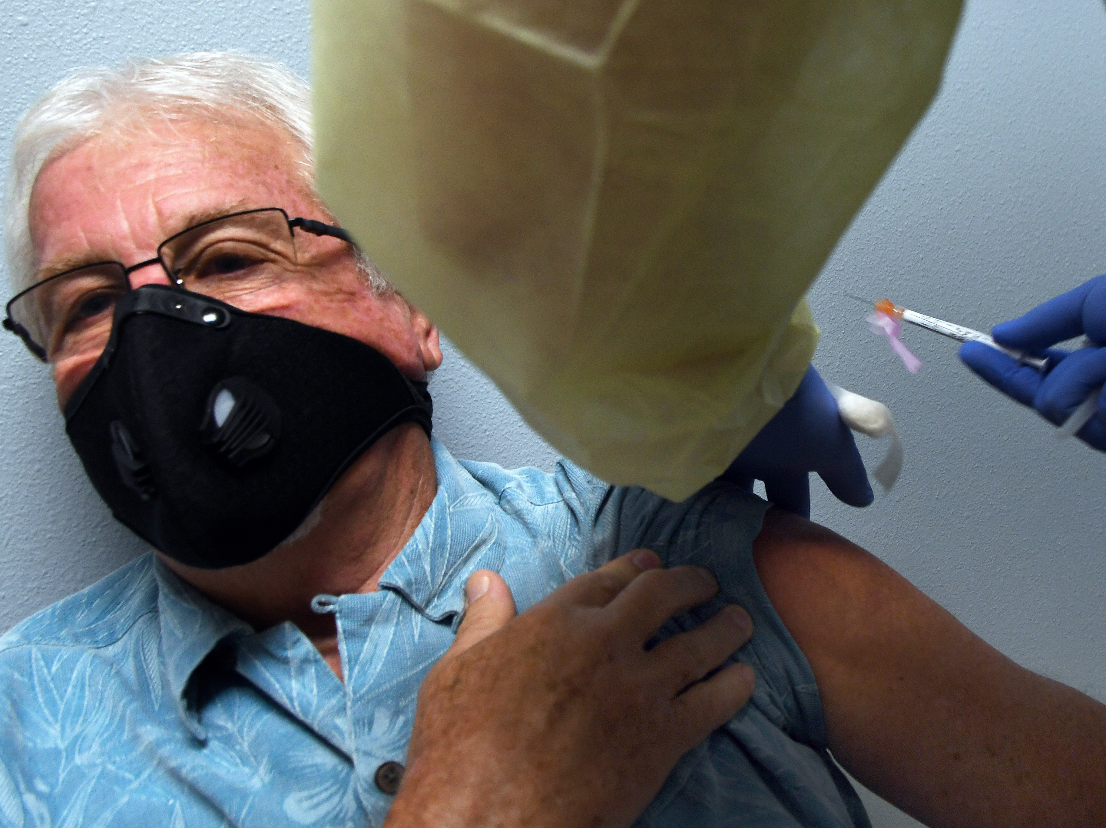 Tony Potts, 69, a retiree from Ormond Beach, Fla., receives his first Moderna COVID-19 vaccine shot Tuesday as part of the company's phase three clinical trial. (NurPhoto via Getty Images)