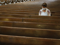 A parishioner sits after Mass last month at a Catholic church in New York City. An overwhelming majority of U.S. adults believe that houses of worship should be subject to the same restrictions on public gatherings that apply to other institutions.