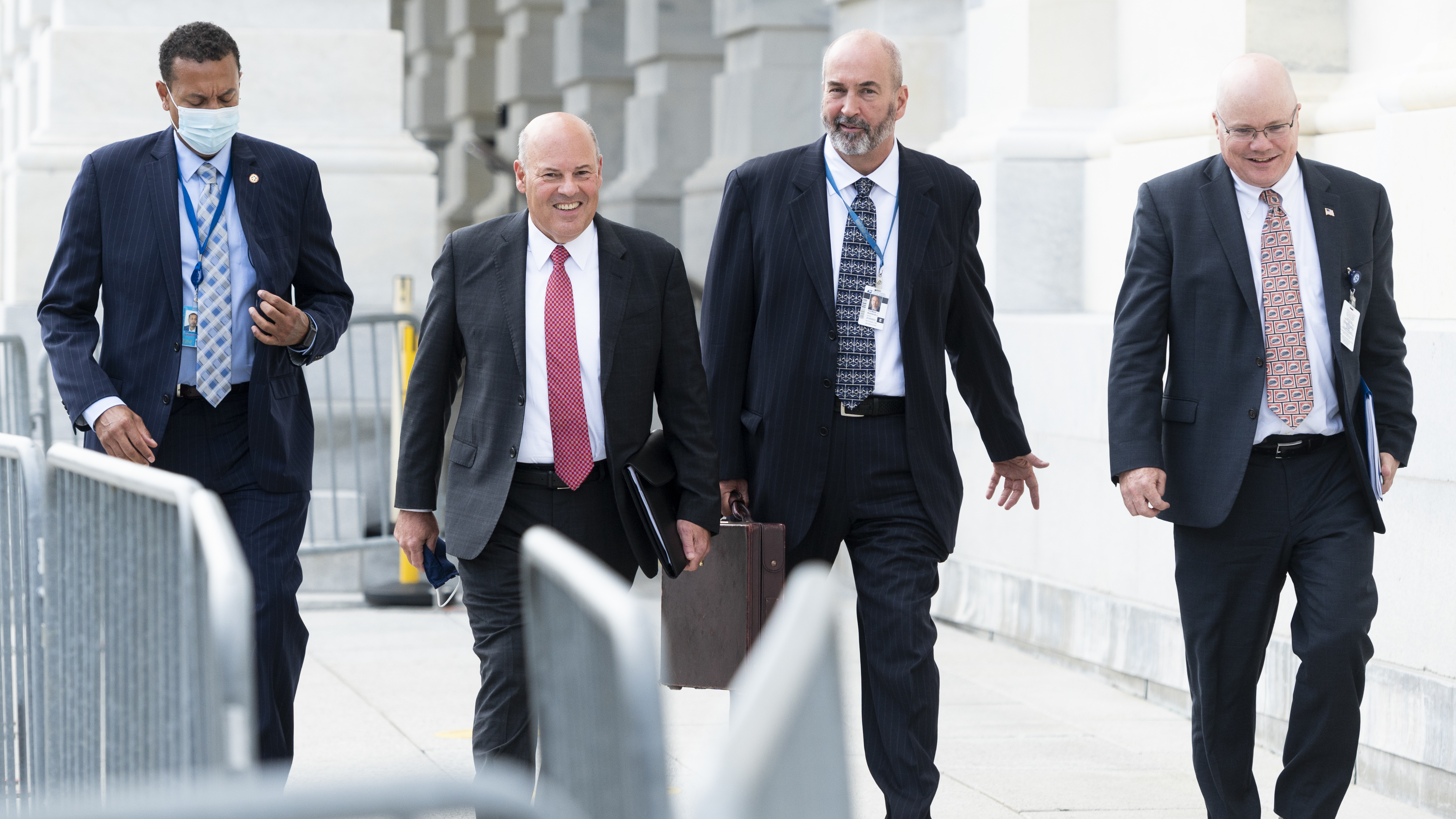 Postmaster General Louis DeJoy, second from left, leaves the U.S. Capitol after meeting Wednesday with Democratic leaders. (CQ Roll Call via Getty Images)