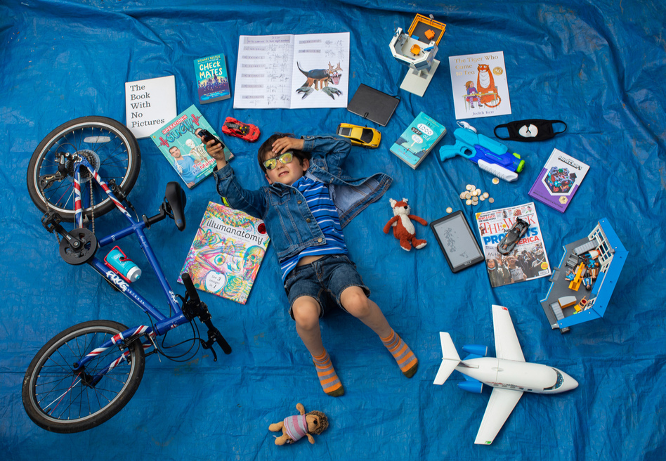 Elizabeth Dalziel's son Joe, 7, lays next to his favorite objects, toys and books as part of a homeschooling assignment — to create a time capsule — from his school in Berkhamsted, England. (Elizabeth Dalziel)