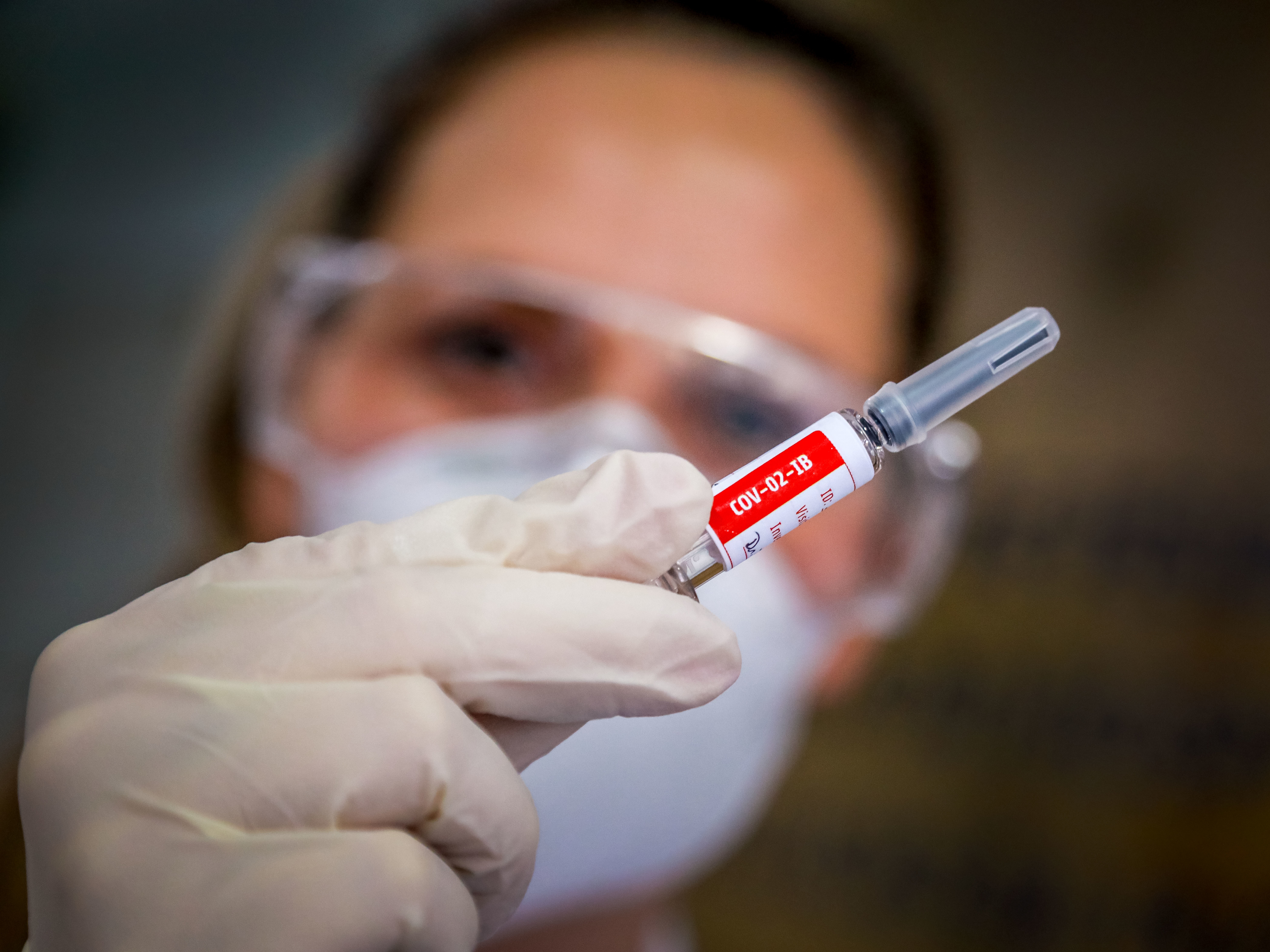 A nurse holds a COVID-19 vaccine candidate produced by Chinese company Sinovac Biotech at the São Lucas Hospital in Porto Alegre, Brazil, on Aug. 8. (AFP via Getty Images)