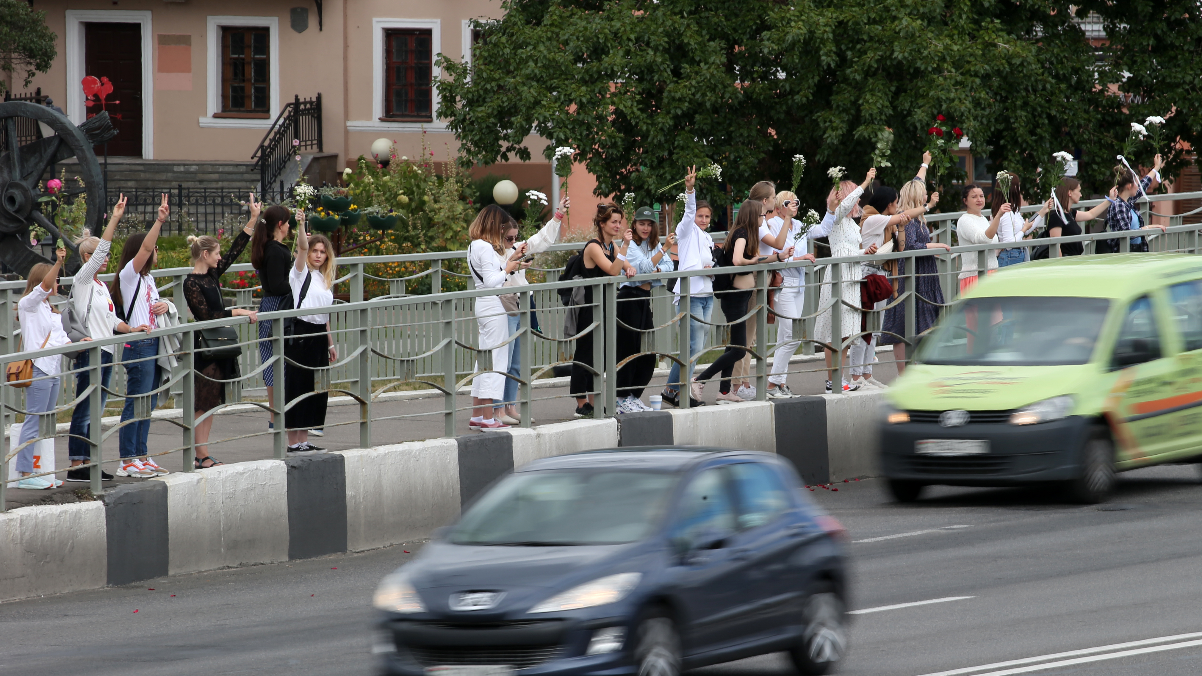 Women hold flowers Thursday in support of demonstrators who were injured or detained during protests critical of election results in Belarus. (Tass via Getty Images)
