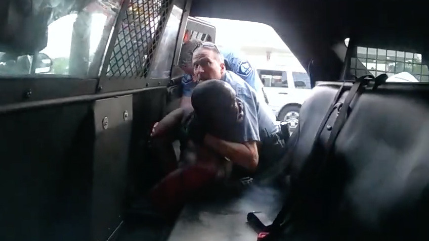 Minneapolis Officer Derek Chauvin is seen struggling to force George Floyd into the back seat of a police SUV in newly released body camera video recorded by Officer Tou Thao. Both Chauvin and Thao were fired, along with two other officers involved in Floyd's death on Memorial Day. All four former officers are facing charges. (Hennepin County/MPR/YouTube/Screenshot by NPR)