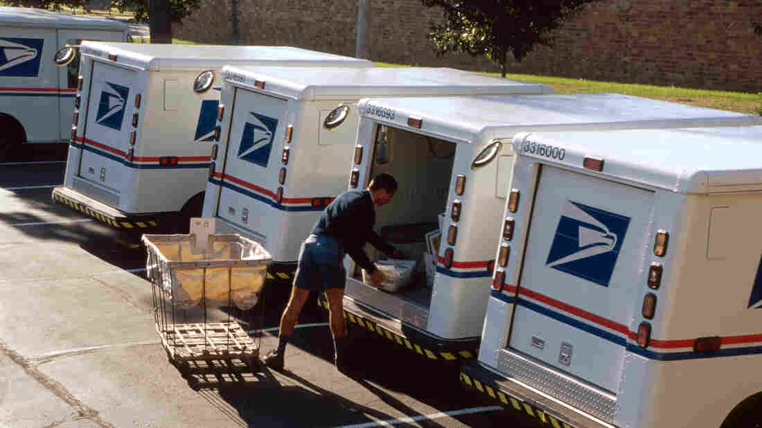 US Post Office, mail carrier loading truck.