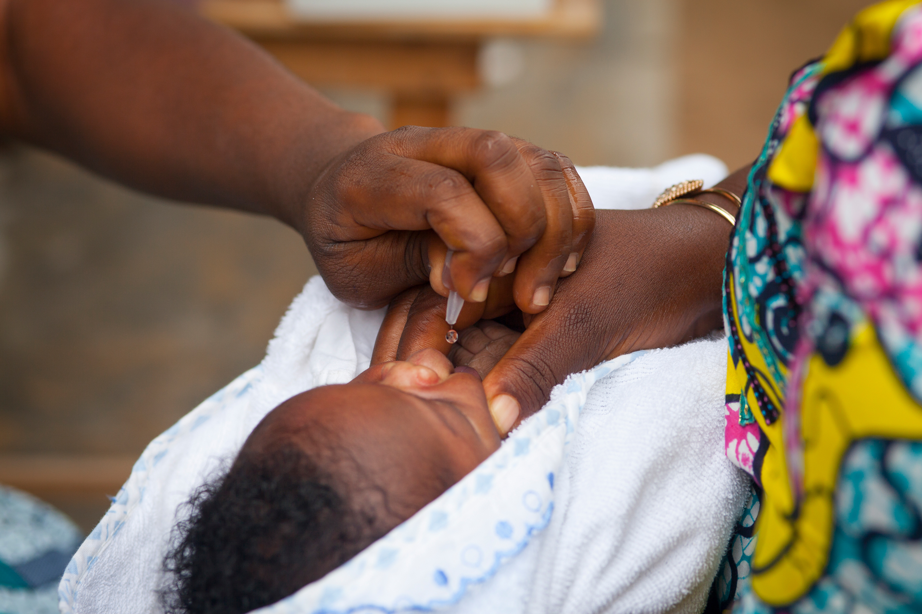 An oral polio vaccine, which contains weakened live virus, is administered in a health enter in Togo. Africa has declared that wild polio has been eradicated, but a relatively small number of cases of vaccine-derived polio persist. (Universal Images Group via Getty)