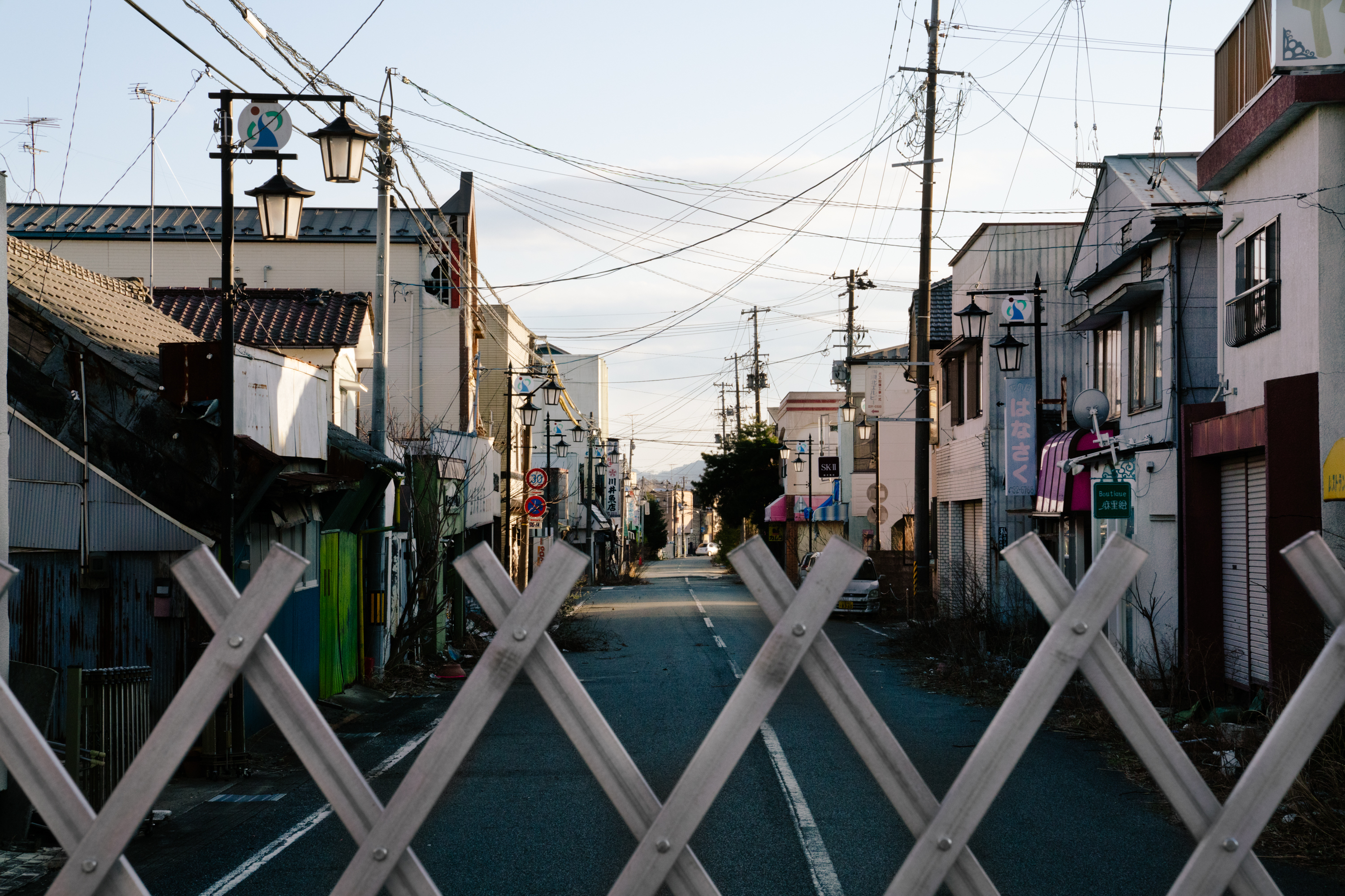A view over a gate blocking off the old downtown of Okuma, in Fukushima Prefecture. Fukushima was forever changed by one of the world's biggest nuclear disasters nearly a decade ago. (NPR)