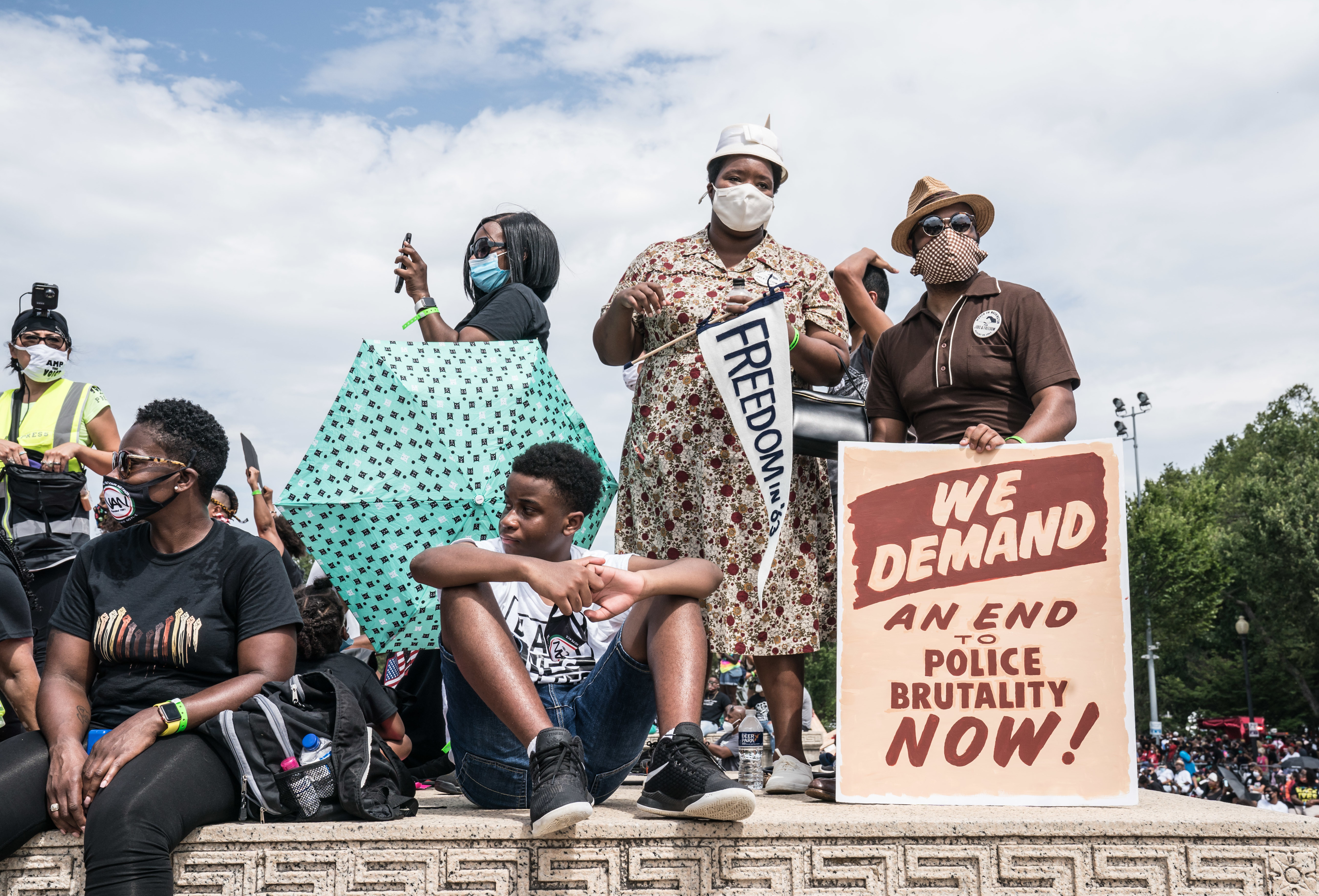 People attend the Commitment March on Friday at the Lincoln Memorial in Washington, D.C., on the 57th anniversary of the March on Washington and the Rev. Martin Luther King Jr.'s &quot;I Have a Dream&quot; speech. (Dee Dwyer/DCist for NPR)