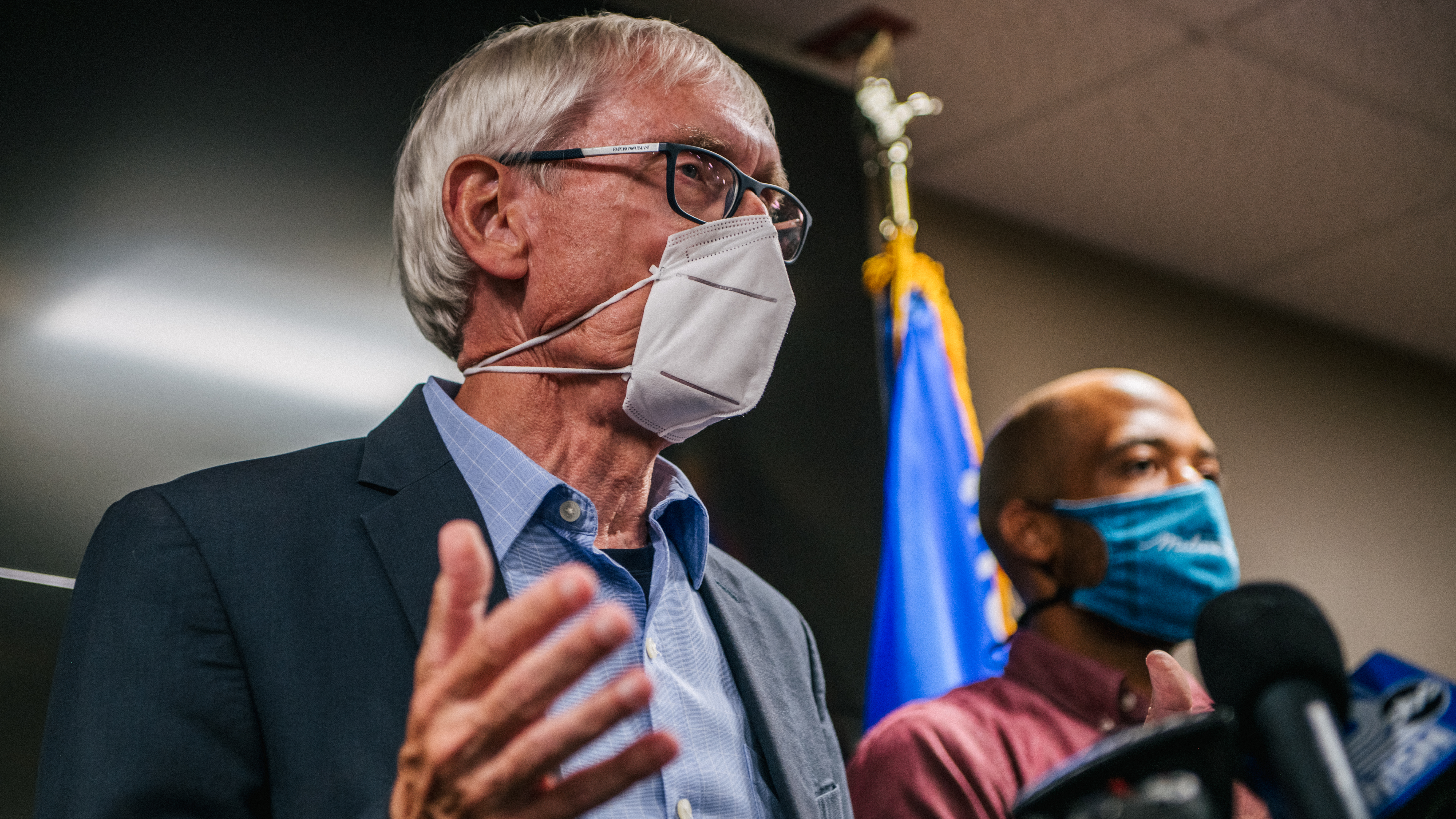 Wisconsin Gov. Tony Evers, left, speaks at a news conference on Aug. 27 in Kenosha, Wis. The news conference was held to discuss the recent civil unrest surrounding the police shooting of Jacob Blake, a Black man who was shot several times in the back in front of his children.