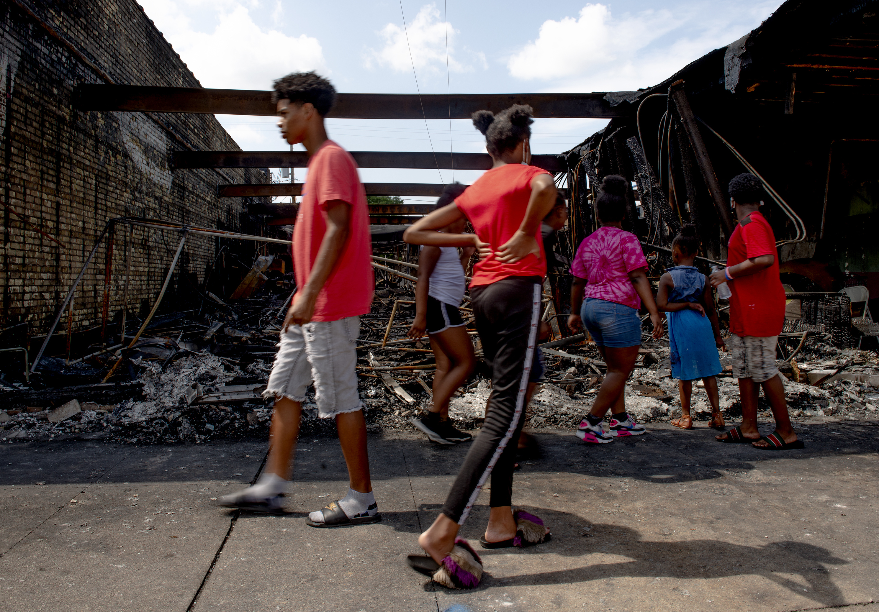 People pass by a destroyed building in Kenosha, WI. (Stephen Maturen for NPR)