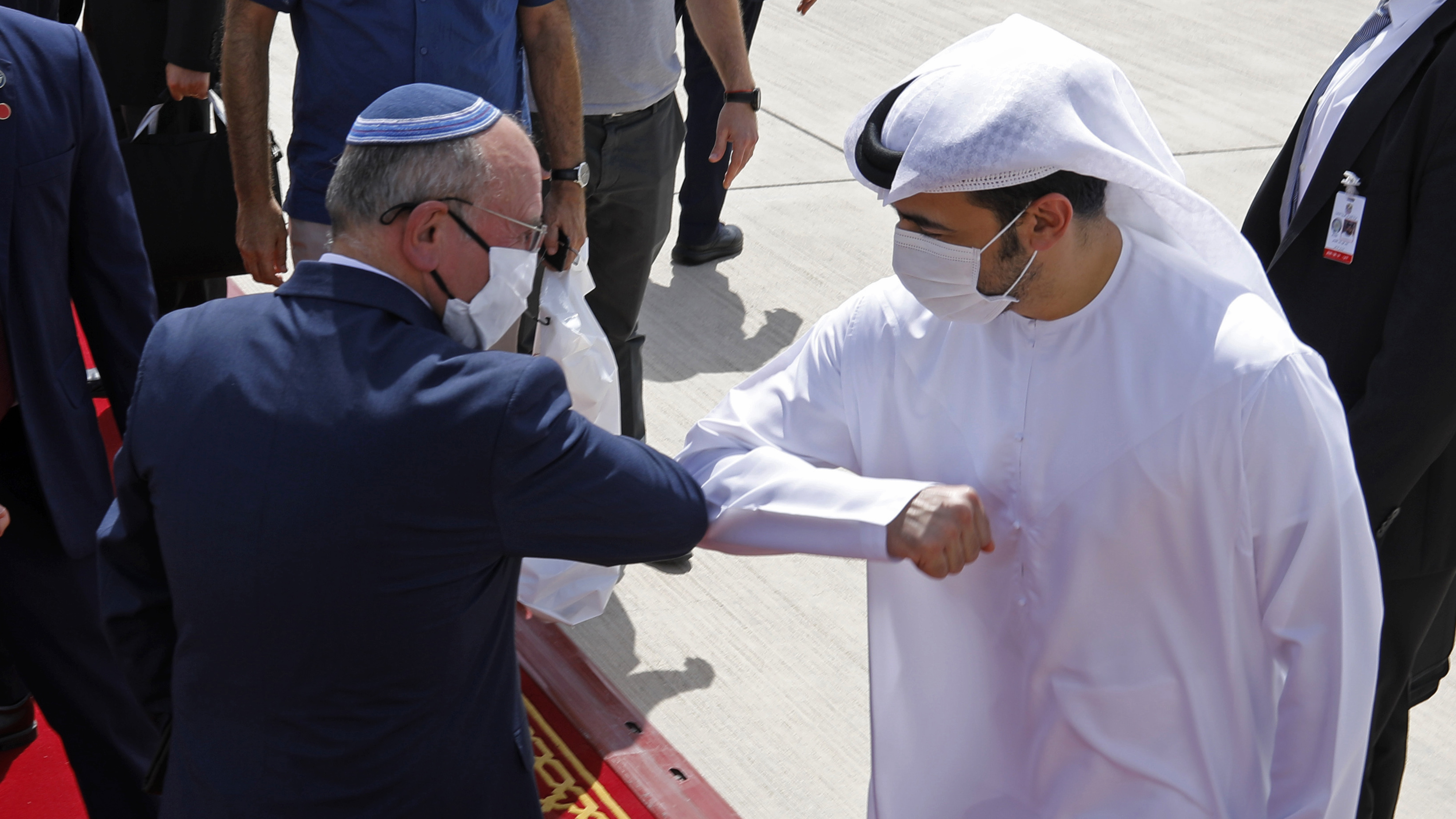 Israeli national security adviser Meir Ben-Shabbat (left) elbow-bumps with an Emirati official as he leaves Abu Dhabi, United Arab Emirates, Tuesday.