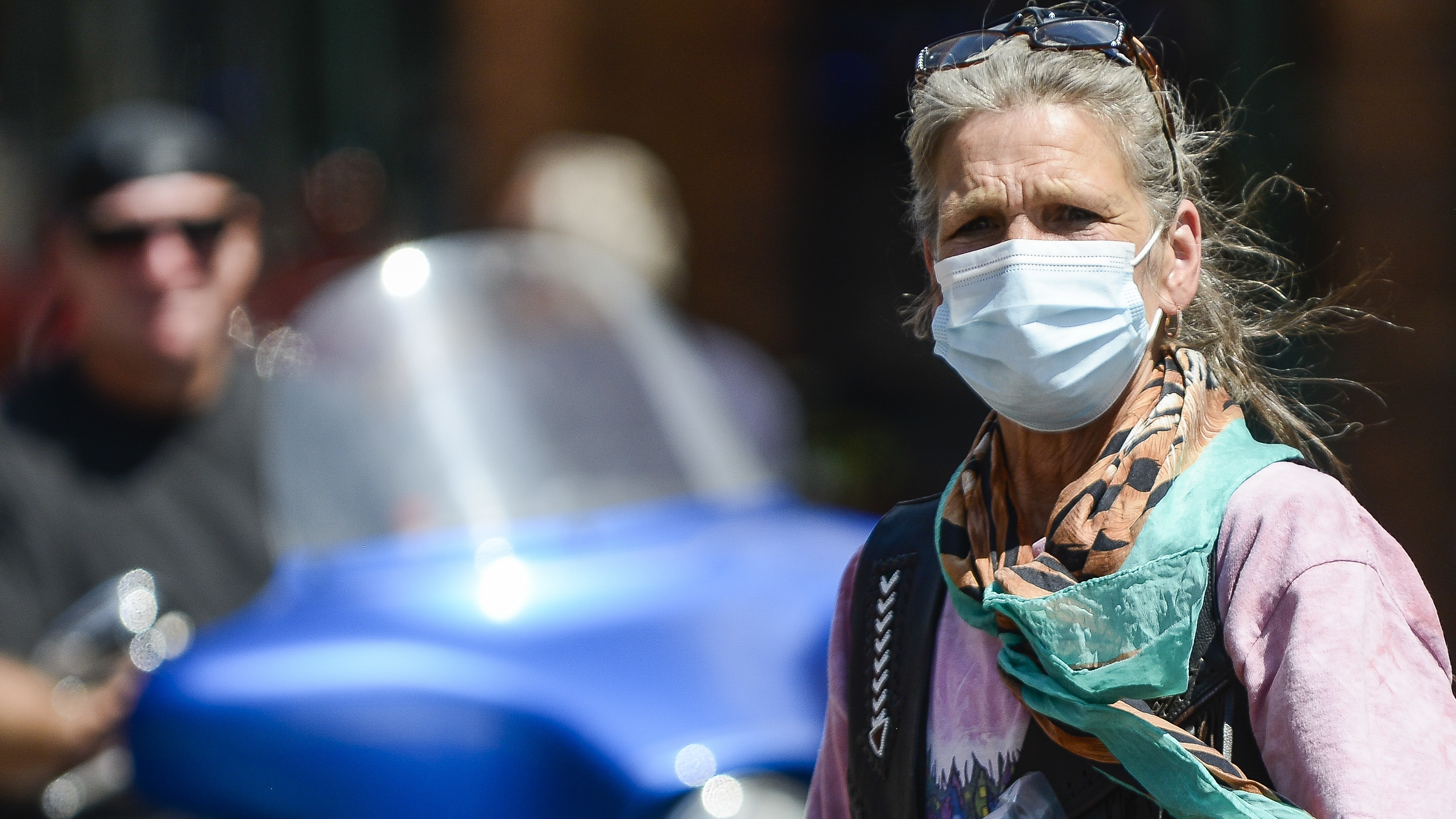 A woman crosses the street as motorcyclists ride through Deadwood, S.D., during the Sturgis Motorcycle Rally. Despite the pandemic, this year's rally drew nearly half a million attendees. (Getty Images)