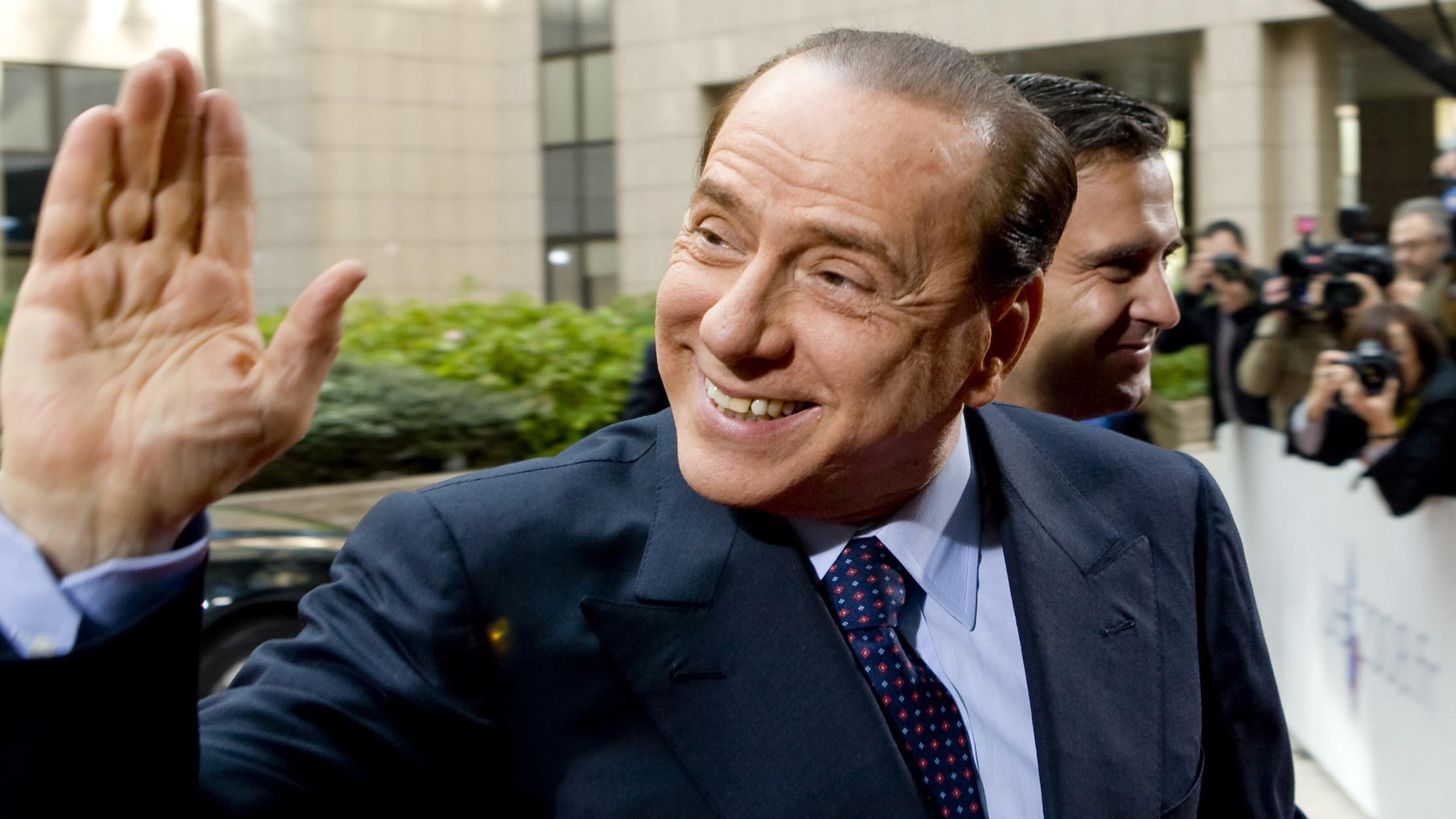 Former Italian Prime Minister Silvio Berlusconi waving at members of the media in Rome, Italy, in 2011. Berlusconi