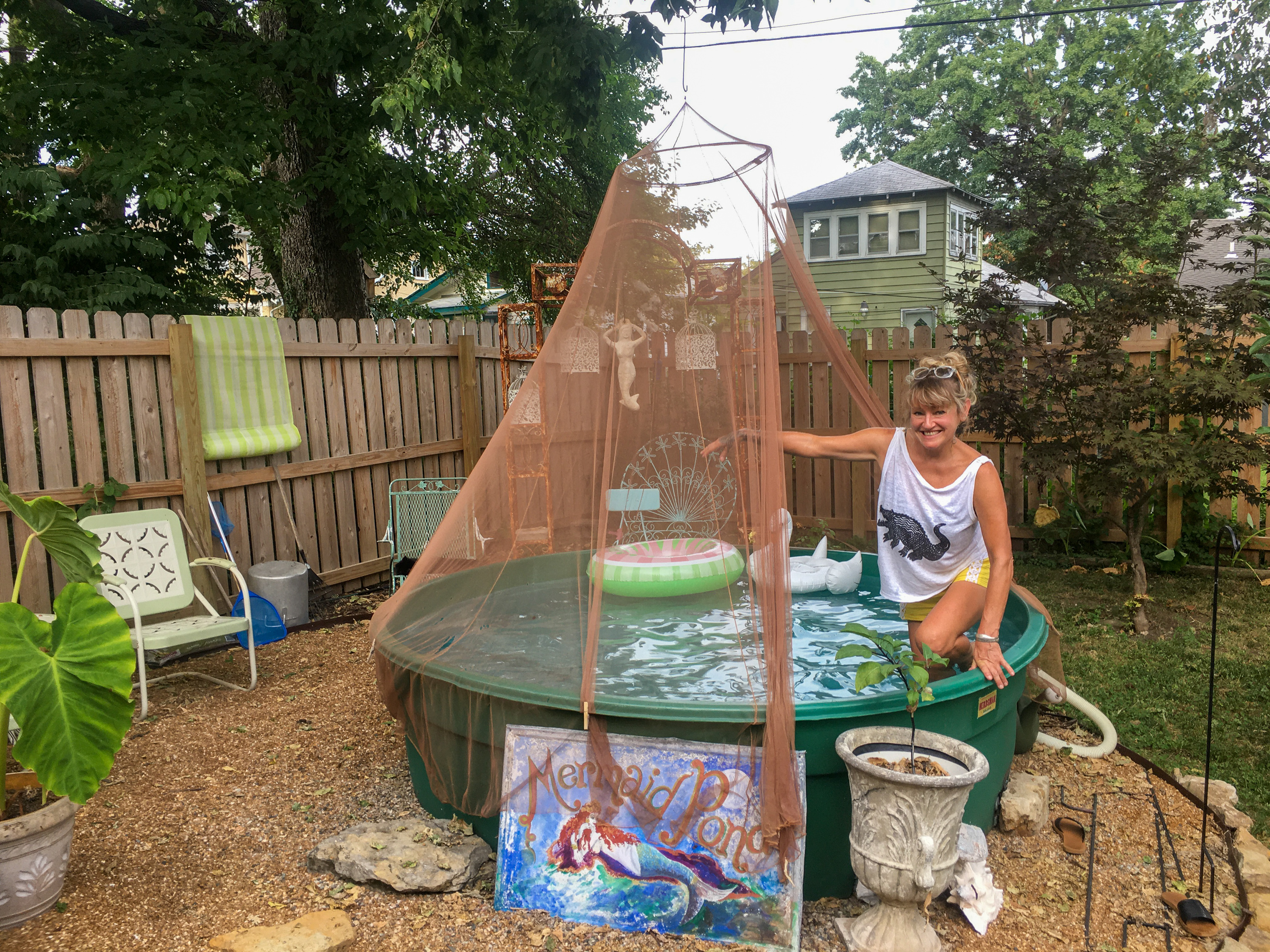 &quot;It used to be a backyard. Now it's a summer oasis,&quot; says Astoria Camille of the water feature she built in her mother's Kansas City, Mo., backyard using an old stock tank and 53 bags of pea gravel. (Frank Morris/KCUR)