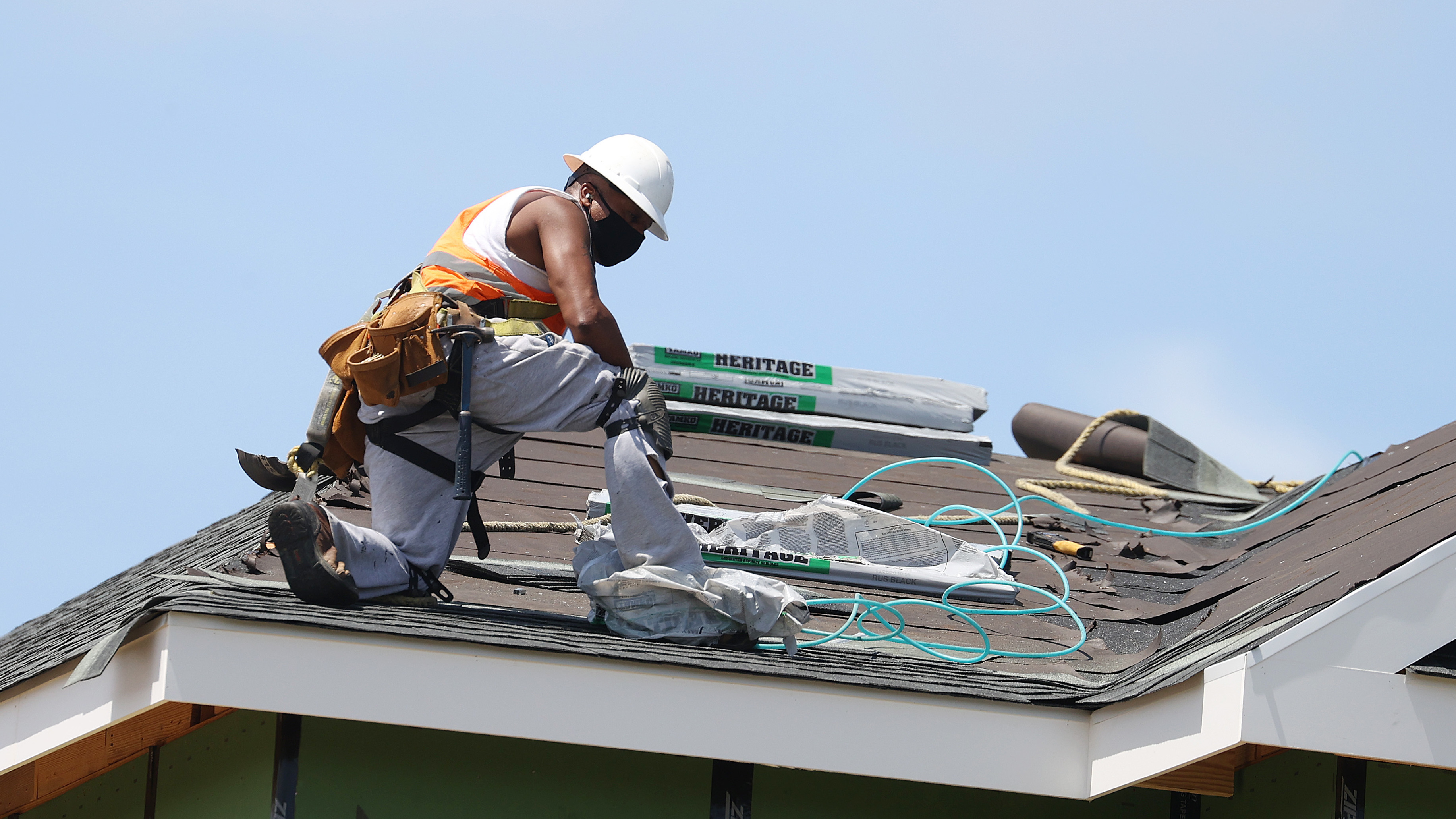 A construction worker roofs an apartment complex in Uniondale, N.Y., on May 27. U.S. employers added fewer jobs last month even as the unemployment rate fell to 8.4%. (Getty Images)