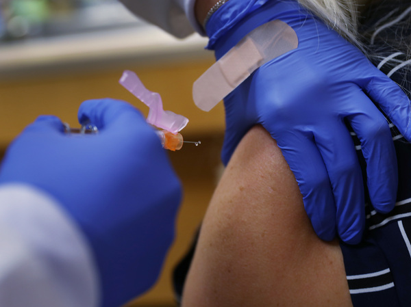 Some of the world's largest vaccine makers hope to bolster public confidence in a yet-to-arrive COVID-19 vaccine, pledging to follow strict safety protocols in the rush to respond to the pandemic. Here, a nurse practitioner administers a dose of flu vaccine in Key Biscayne, Fla.