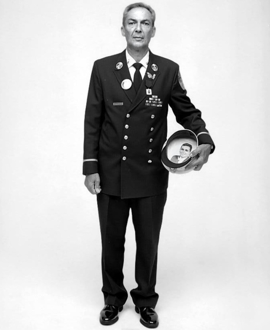 Retired NYPD Chief Albert Petrocelli, in 2002, with a photo of Mark that he carried inside his hat.