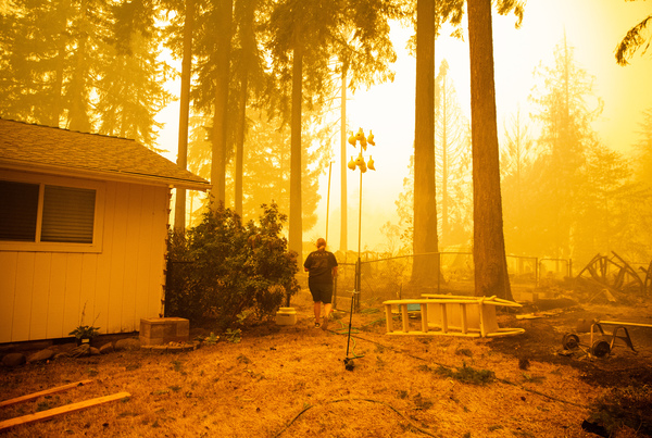 Chelsea DeVos scrambles to salvage possessions from her home as the Santiam Fire approaches near Gates.