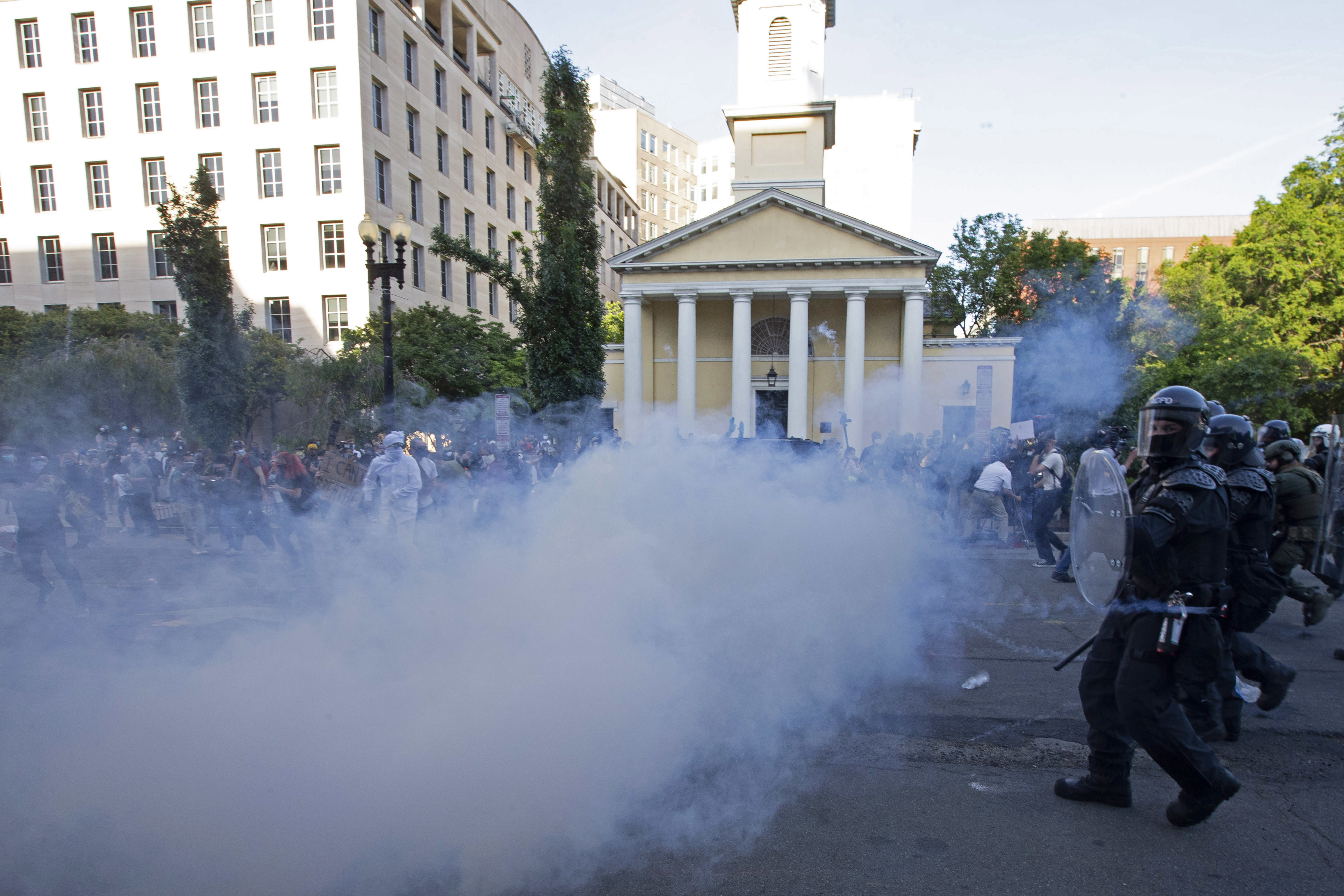 Police move in on demonstrators in Lafayette Square near the White House with tear gas and smoke on June 1. U.S. Park Police made announcements asking protesters to leave, but few people appeared to hear them. (AFP via Getty Images)