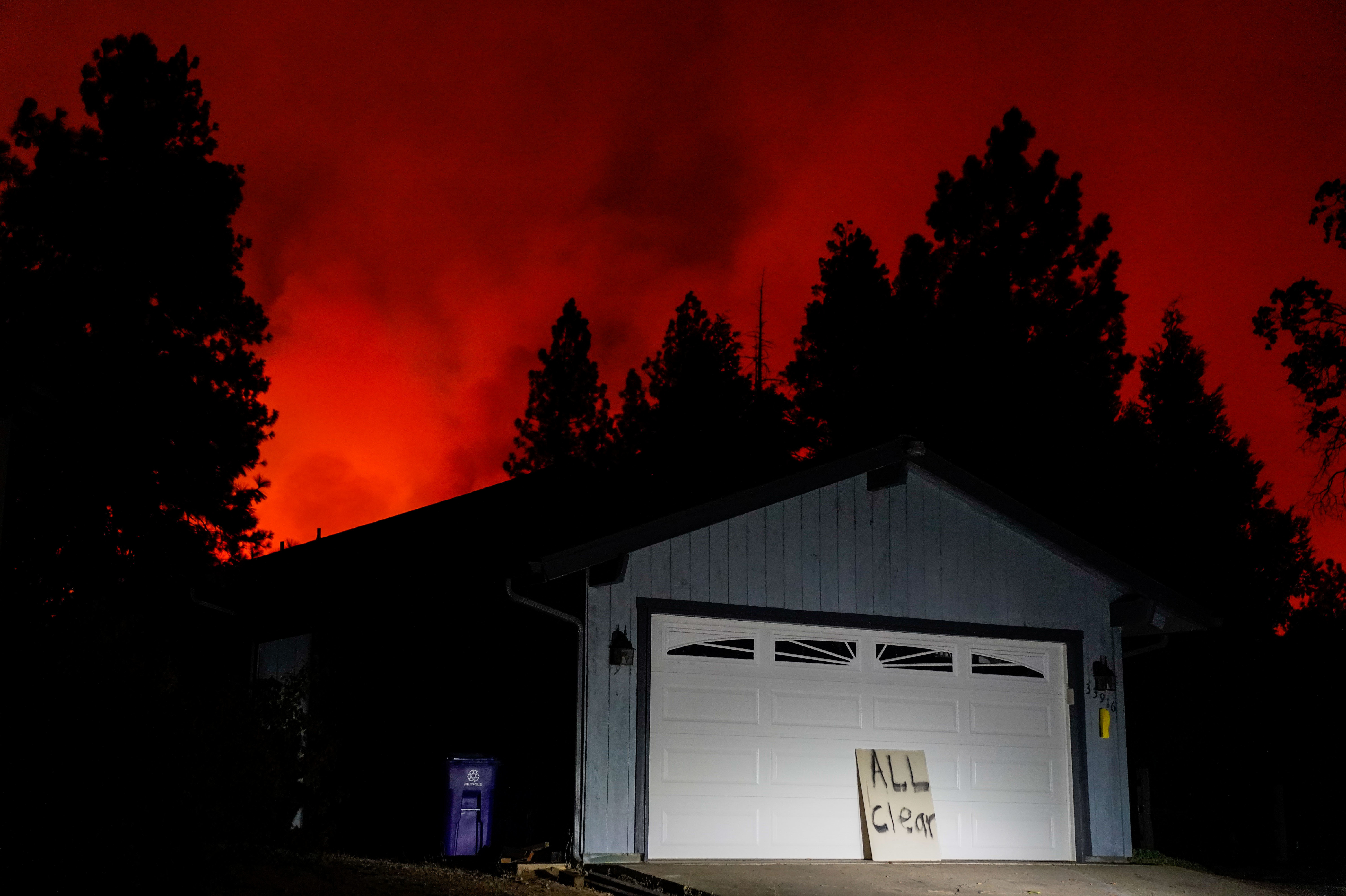 An &quot;All Clear&quot; sign stands in front of a house as the Creek Fire creeps up in Auberry, Calif. on Sept. 8. (Los Angeles Times/Getty Images)