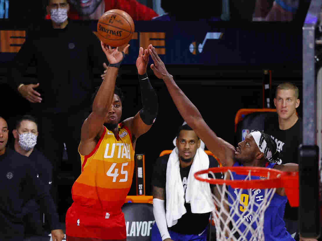LAKE BUENA VISTA, FLORIDA - AUGUST 30: Donovan Mitchell #45 of the Utah Jazz shoots a three point basket against Jerami Grant #9 of the Denver Nuggets during the fourth quarter in Game Six of the Western Conference First Round during the 2020 NBA Playoffs at AdventHealth Arena at ESPN Wide World Of Sports Complex on August 30, 2020. (Photo by Kevin C. Cox/Getty Images)